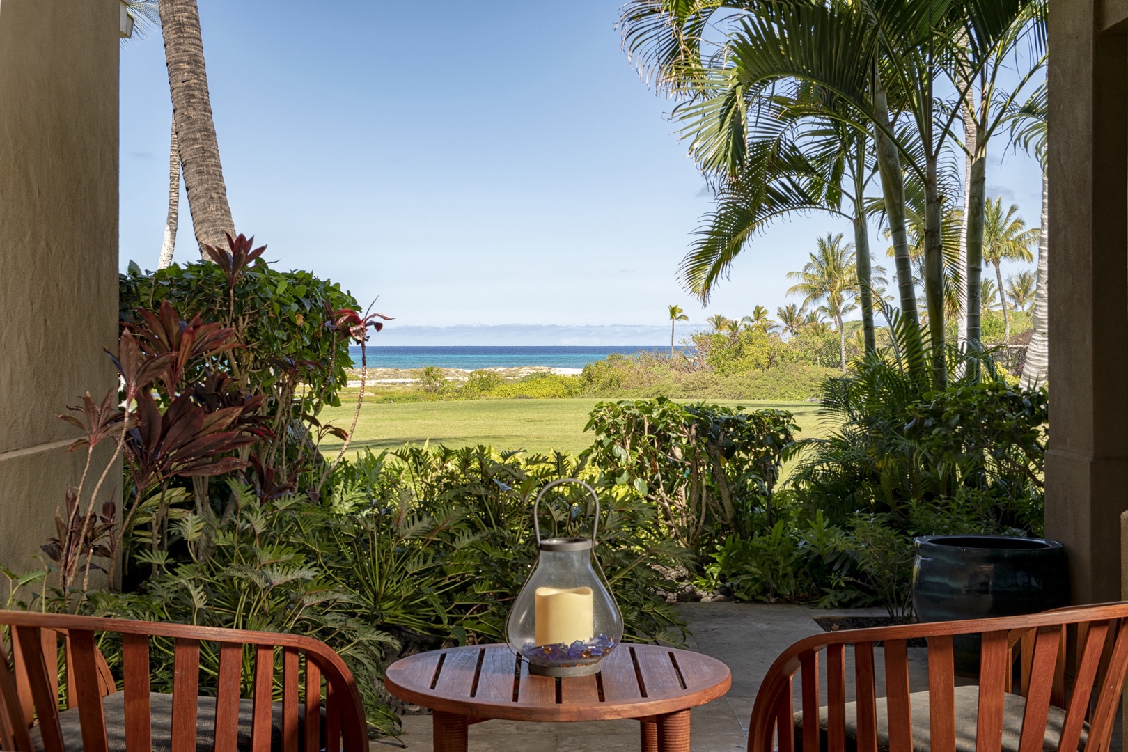 Kailua Kona Vacation Rentals, 3BD Golf Villa (3101) at Hualalai Resort - Primary lanai w/ocean view & tropical foliage.