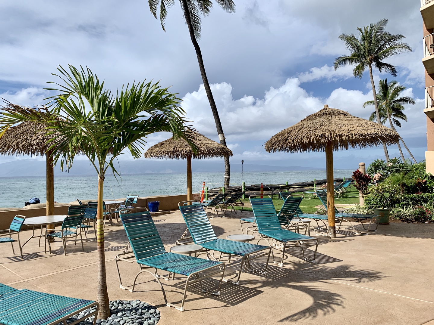 Lahaina Vacation Rentals, Royal Kahana 610 - Lounge under the shade of a thatched umbrella and enjoy the ocean breeze by the water.