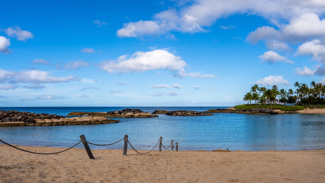 Kapolei Vacation Rentals, Fairways at Ko Olina 7A - Protected lagoon with calm turquoise waters, golden sand beach, and swaying palms creates a tropical paradise setting.
