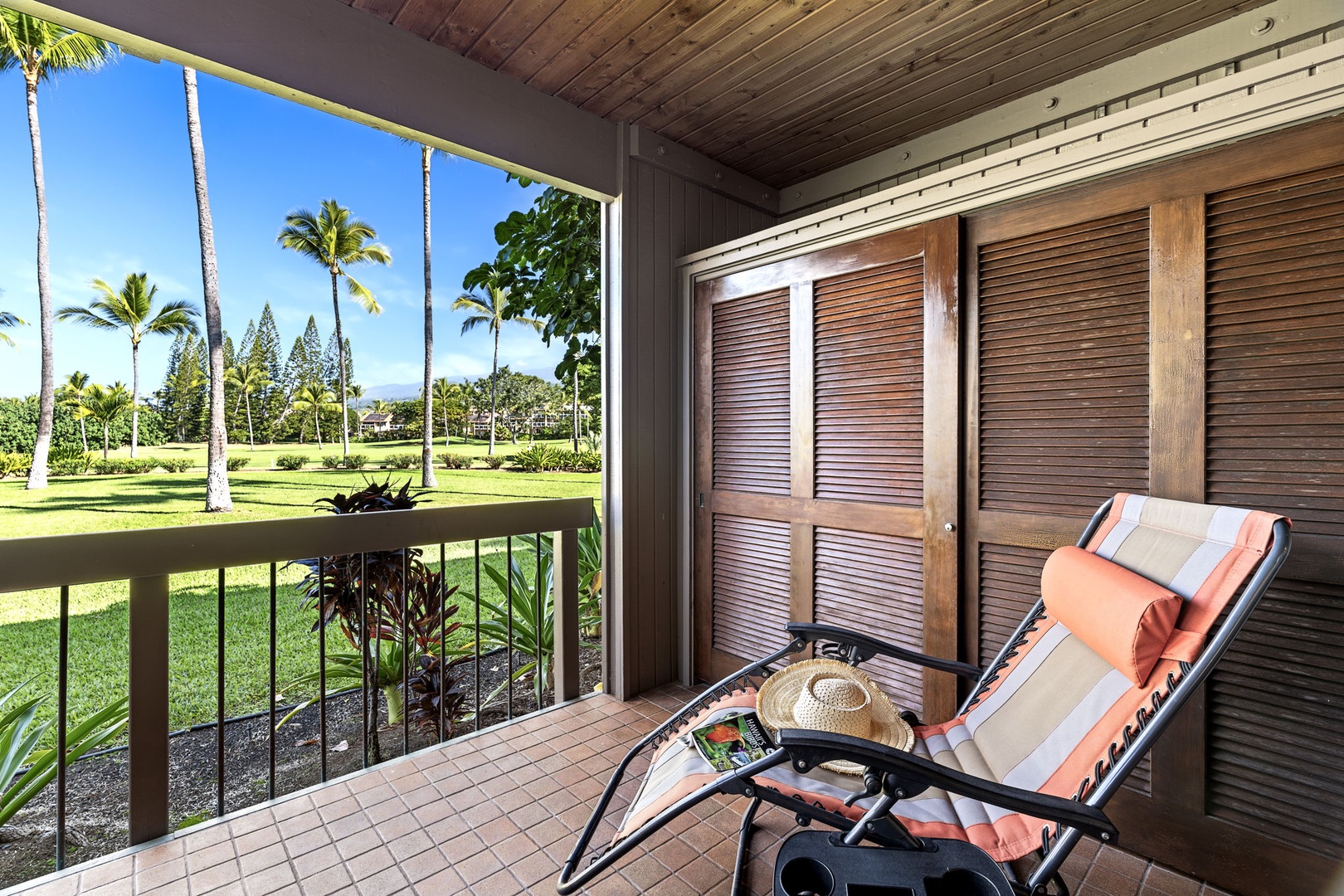 Kailua Kona Vacation Rentals, Kanaloa at Kona 701 - Relax on your private lanai with tropical views of swaying palms and emerald lawns stretching toward the horizon.