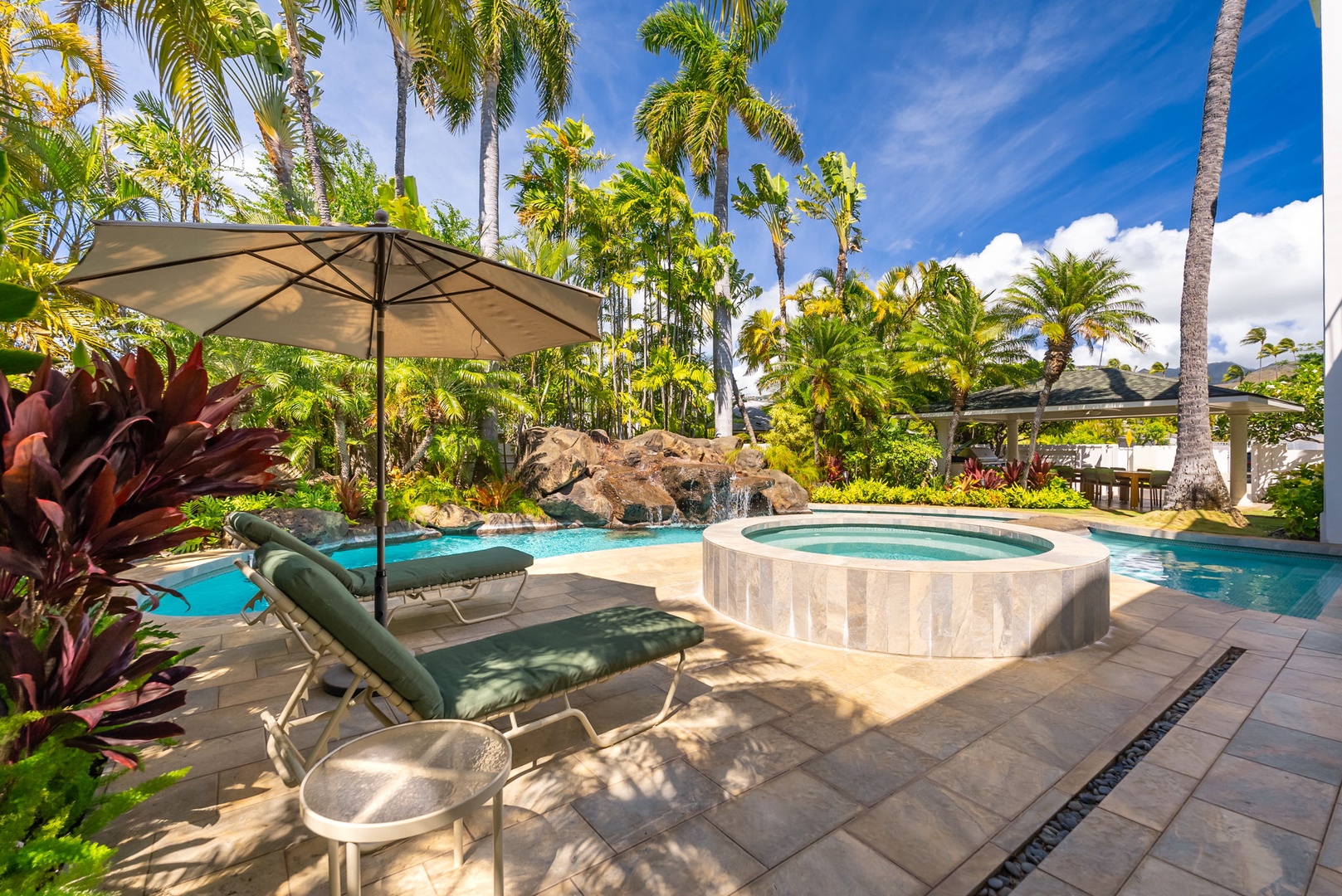 Honolulu Vacation Rentals, Kahala Oasis - Relaxing poolside lounge area with comfortable seating and umbrellas, ideal for unwinding in the shade.