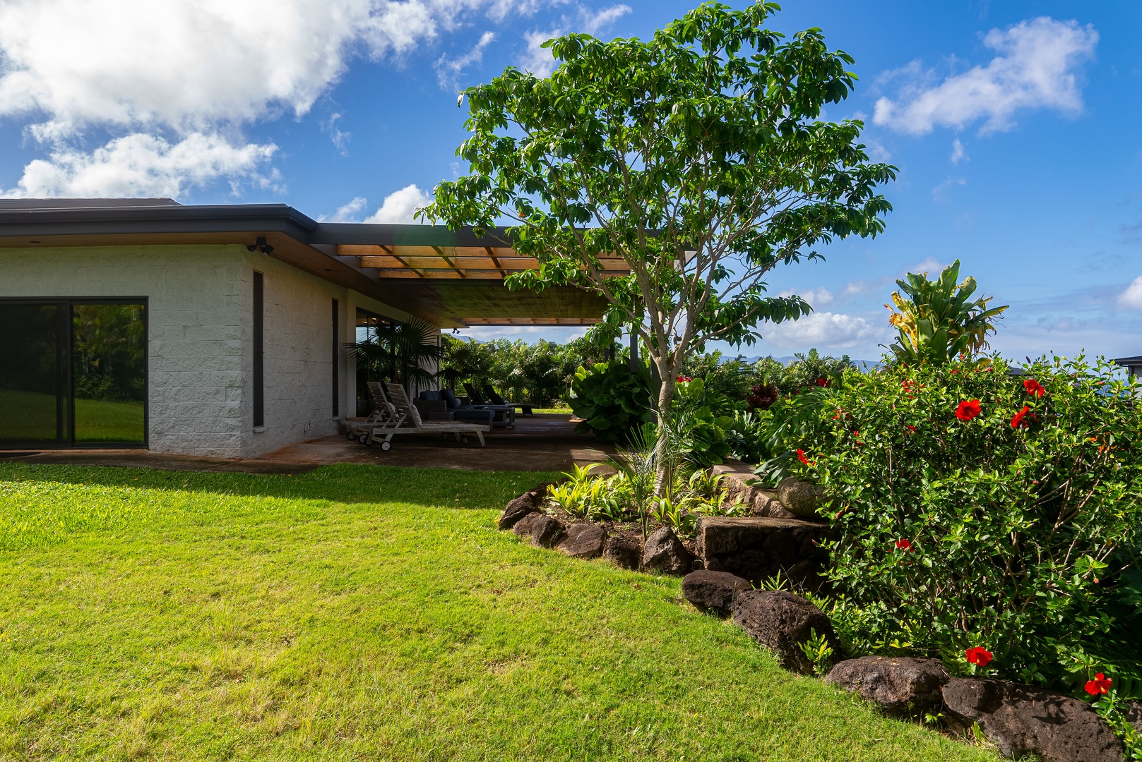 Haleiwa Vacation Rentals, Hale Mahina - Enjoy a wide grassy yard dotted with tropical plants and room to spread out.