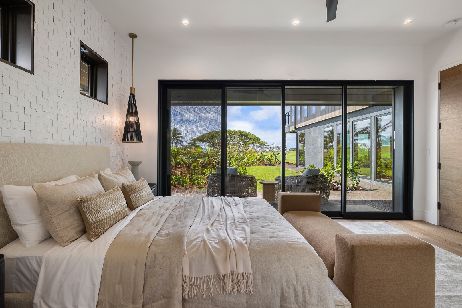Koloa Vacation Rentals, Hale o ka Nene - Retreat to the guest suite with a cozy king bed framed by lush greenery and whispering palms just beyond your window.