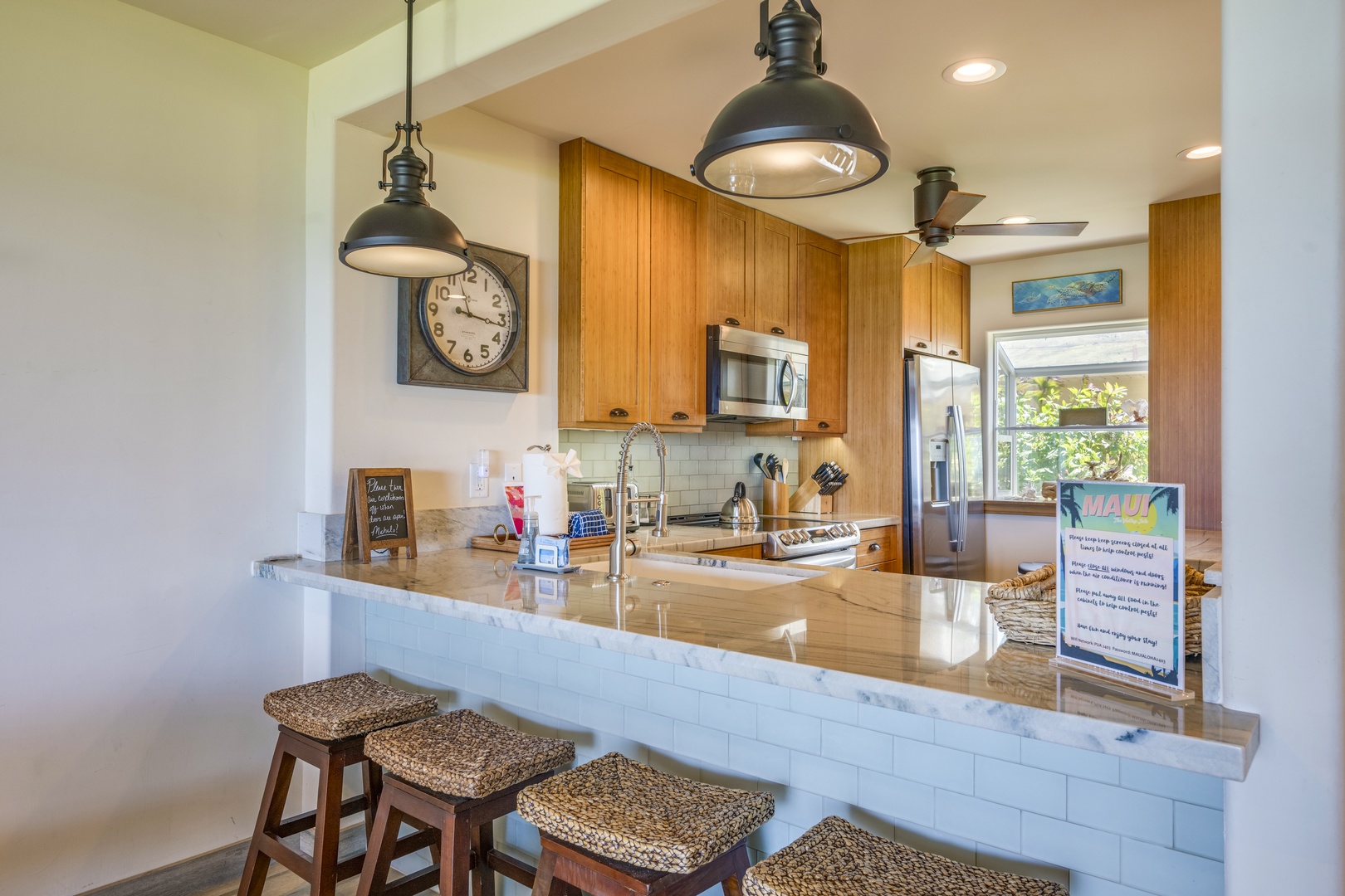 Lahaina Vacation Rentals, Puamana 240-3 - Elegant breakfast bar with seating, inviting you to savor casual meals or morning coffee.