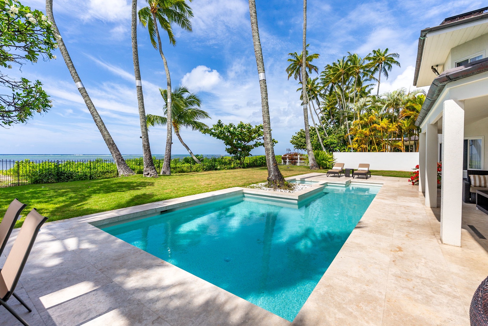 Honolulu Vacation Rentals, Paradise Beach Estate - Soak up the sun or take a refreshing dip in the heated in-ground pool—framed by royal palms and beachfront views.