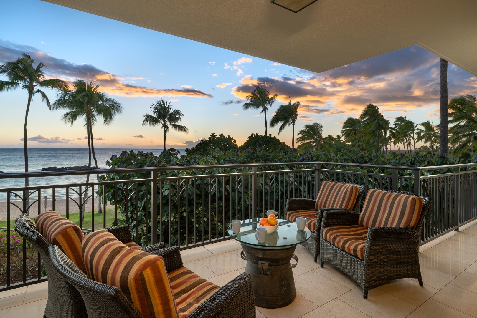 Kapolei Vacation Rentals, Ko Olina Beach Villas B210 - Relax in lanai lounge seating overlooking palms and surf.