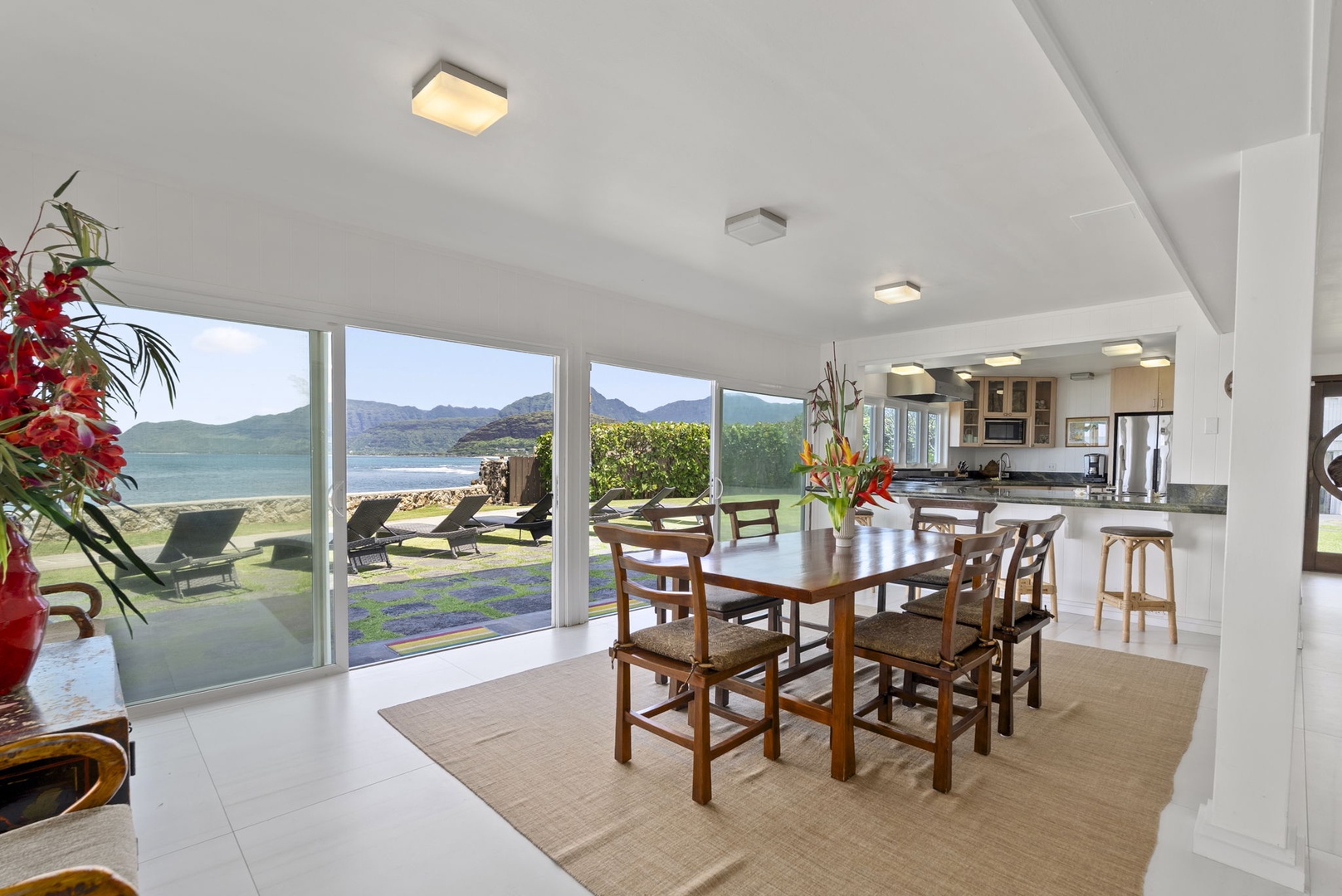 Waianae Vacation Rentals, Ma'ili Blue Estate - Your dining space opens to breathtaking ocean views where morning coffee feels magical with mountains and beach beyond the glass.