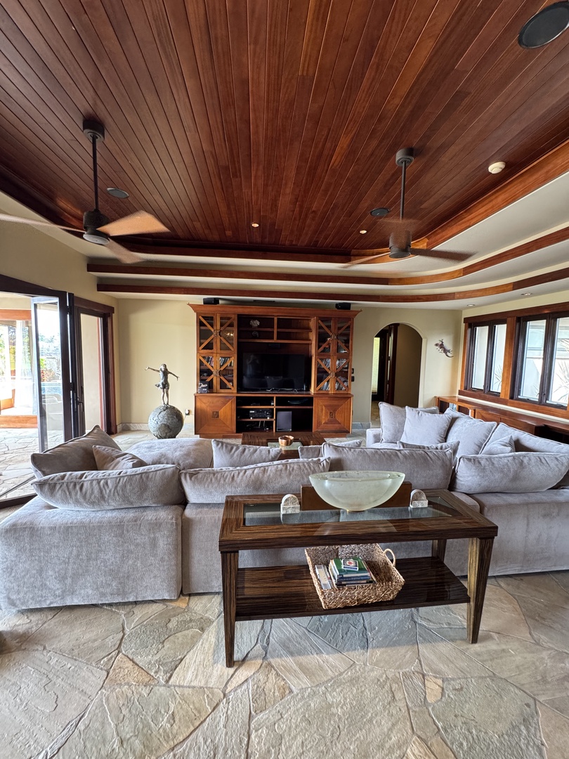 Kamuela Vacation Rentals, Hale Konane - Unwind in the inviting living area with plush seating and a rich wood-paneled ceiling.