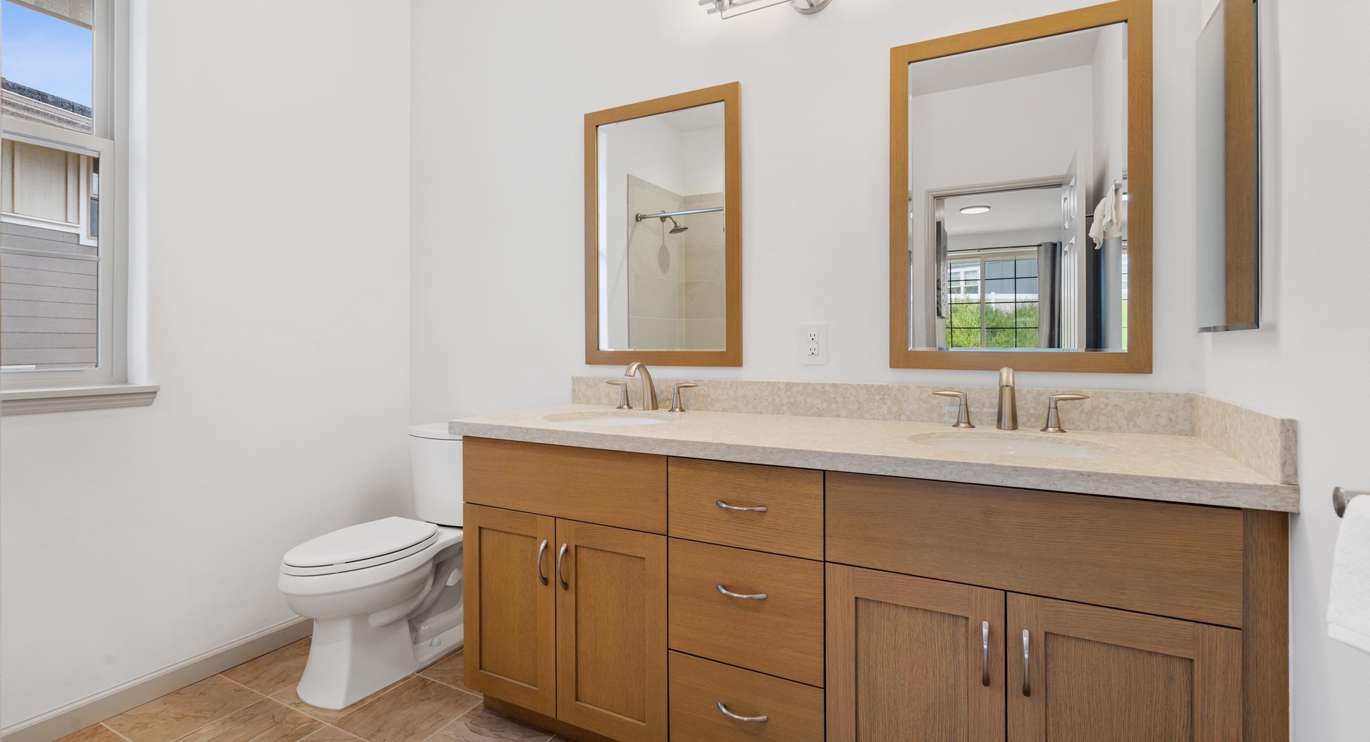 Makaha Valley Vacation Rentals, Makaha Valley Hale Kai** - Modern bathroom with dual sinks and bright lighting, ideal for getting ready together.