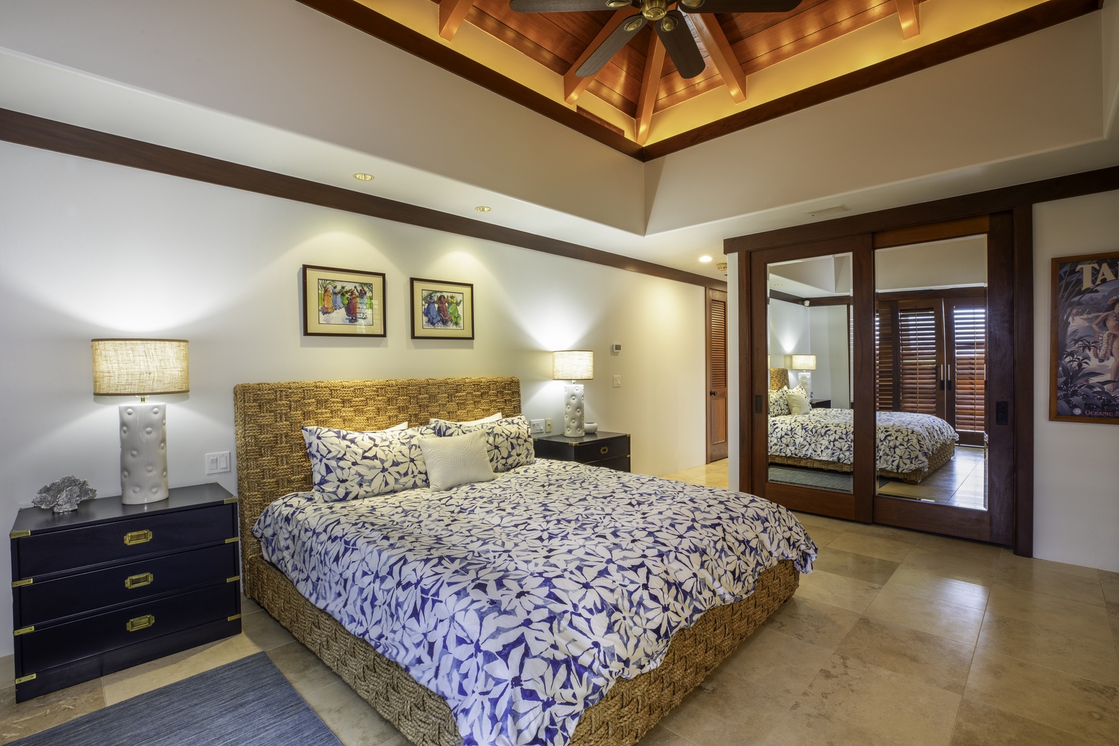 Kamuela Vacation Rentals, Champion Ridge 7 - Unwind in your master suite featuring a handwoven rattan bed, exposed beam ceiling, and mirrored wardrobe that doubles your tropical paradise.