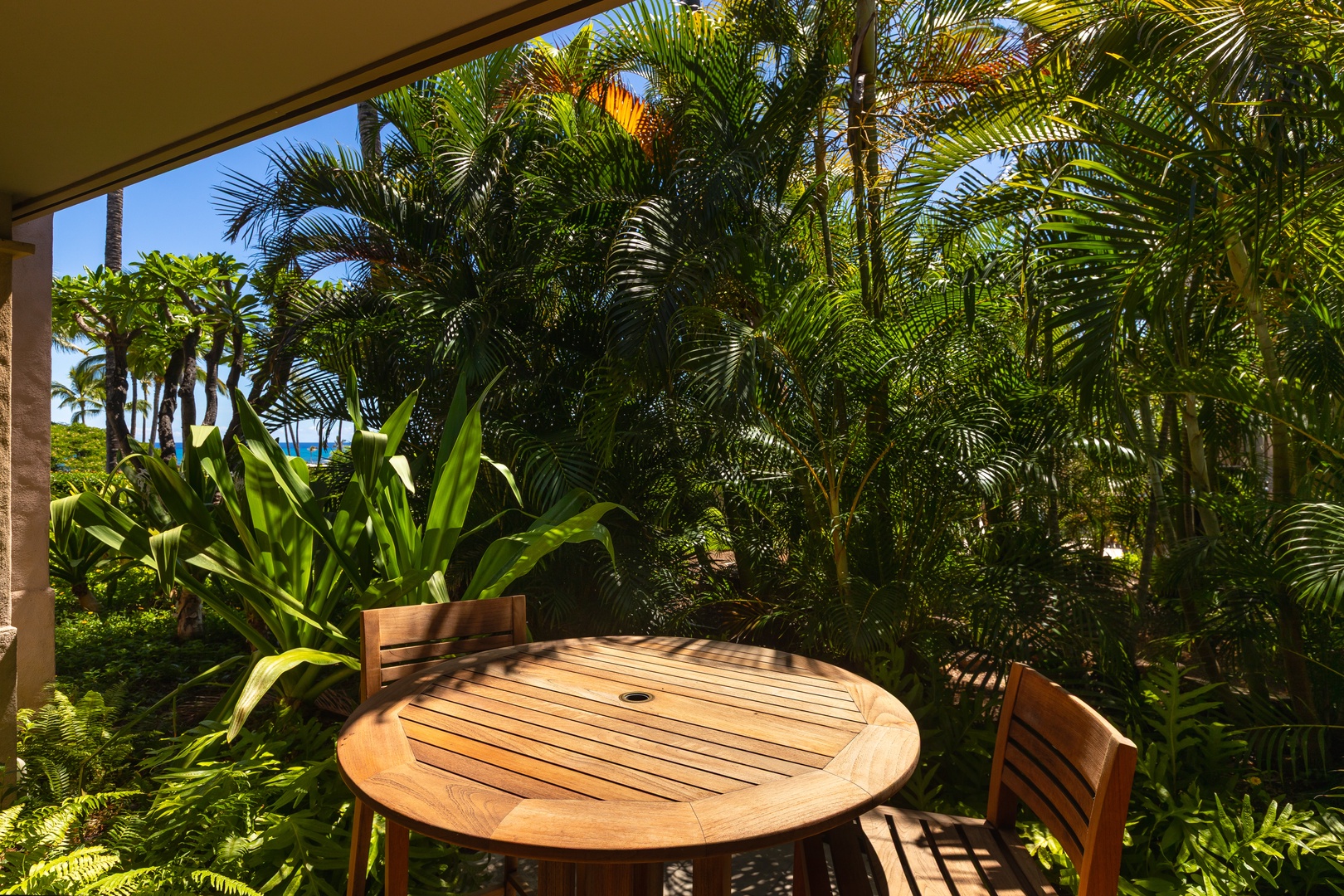Kailua Kona Vacation Rentals, 2BD Hillside Villa (4102) at Hualalai Resort - Intimate bistro table tucked among lush tropical foliage.