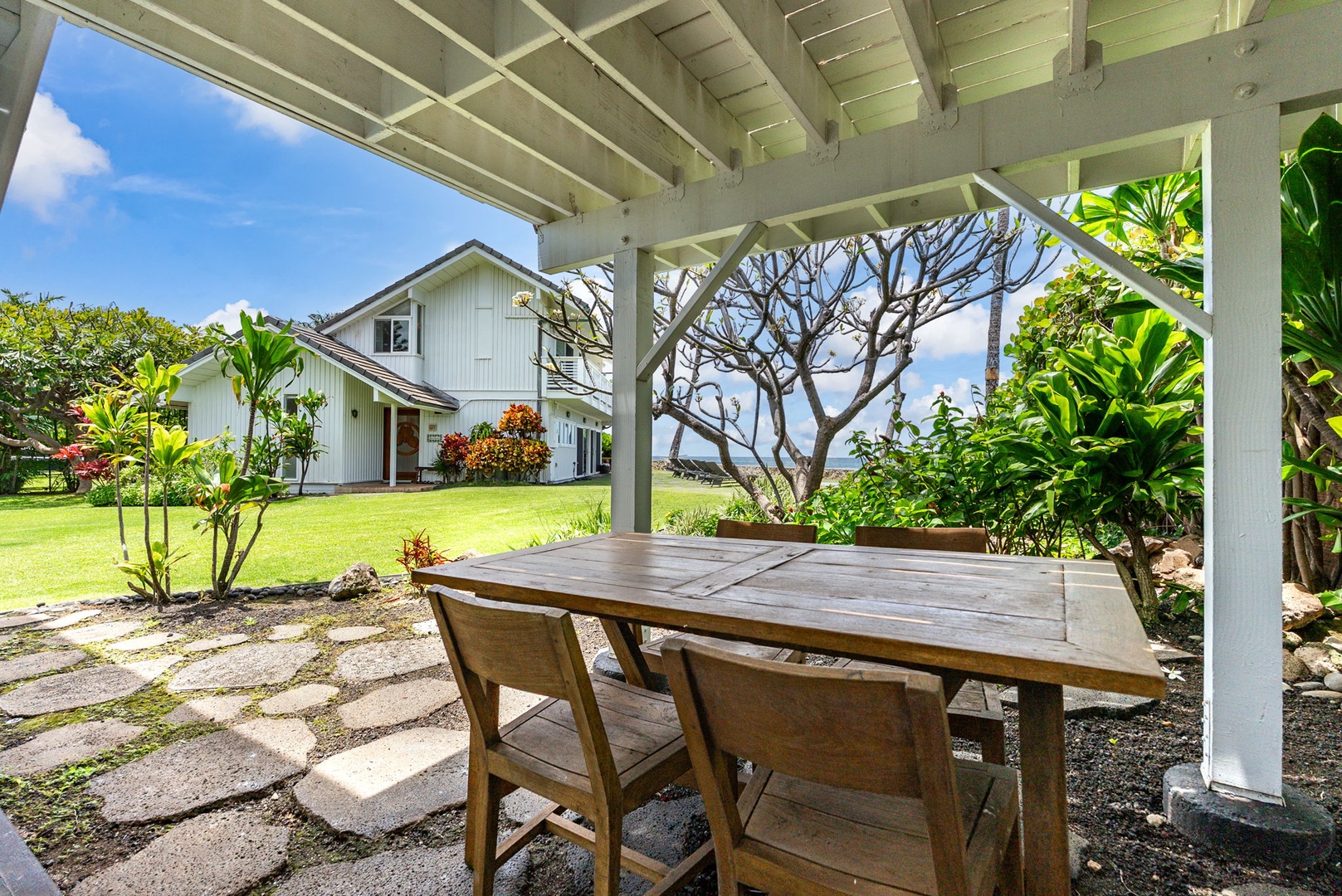 Waianae Vacation Rentals, Ma'ili Blue Estate - Gather for meals under your covered terrace, where tropical gardens and ocean glimpses create the perfect dining backdrop.