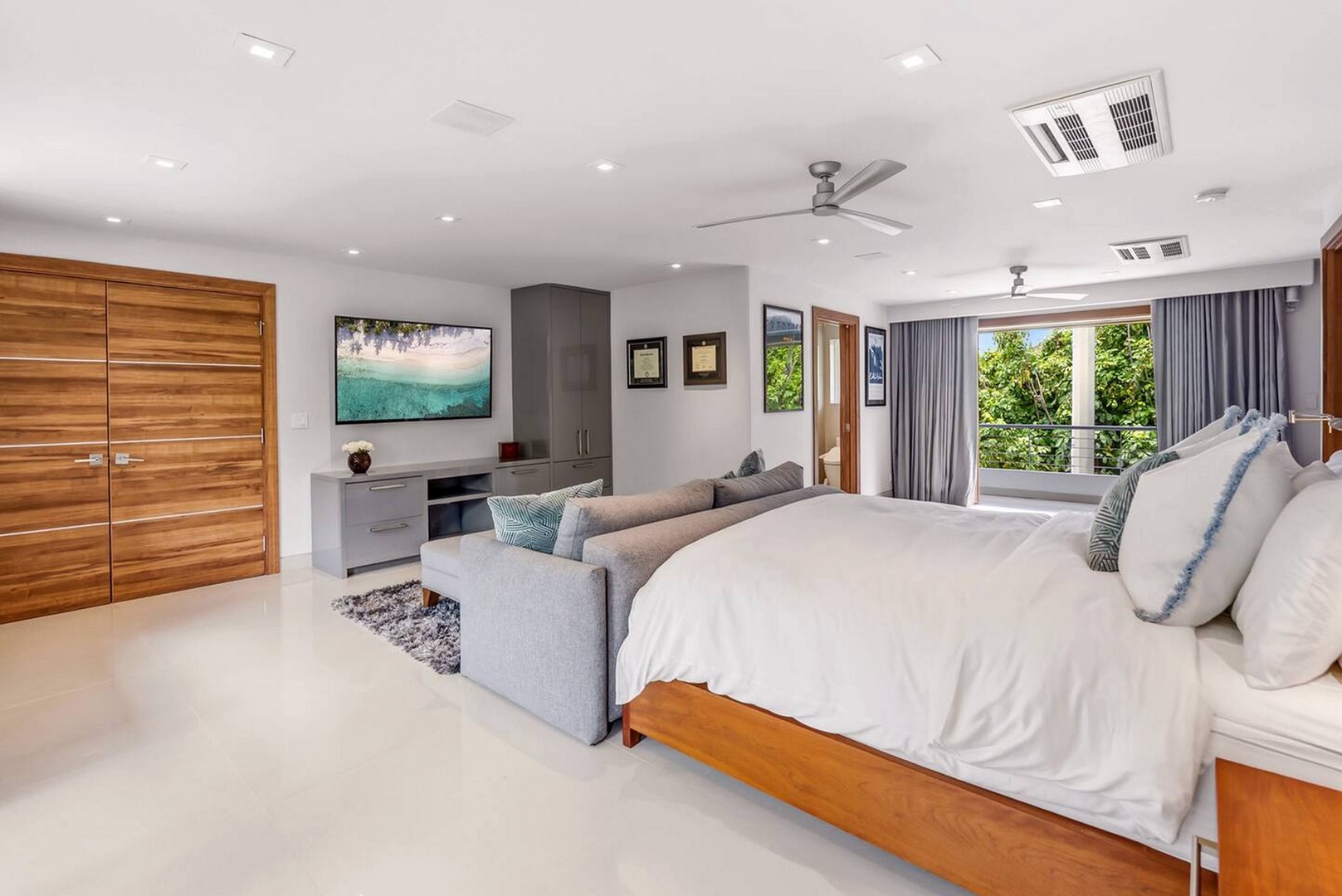 Honolulu Vacation Rentals, Diamond Head Beachfront Estate 9BR - A calm bedroom that opens to garden green just past the glass.
