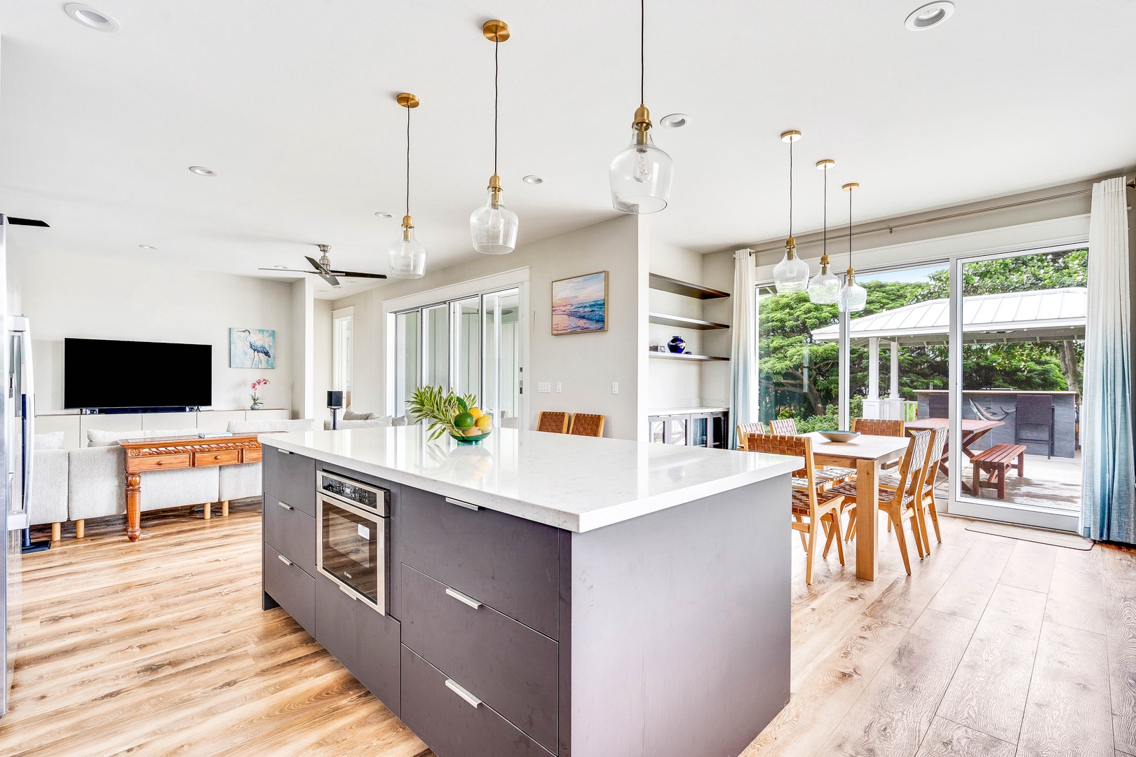 Koloa Vacation Rentals, JC Surf House - Sleek kitchen with island seating flows into the dining area for easy entertaining.