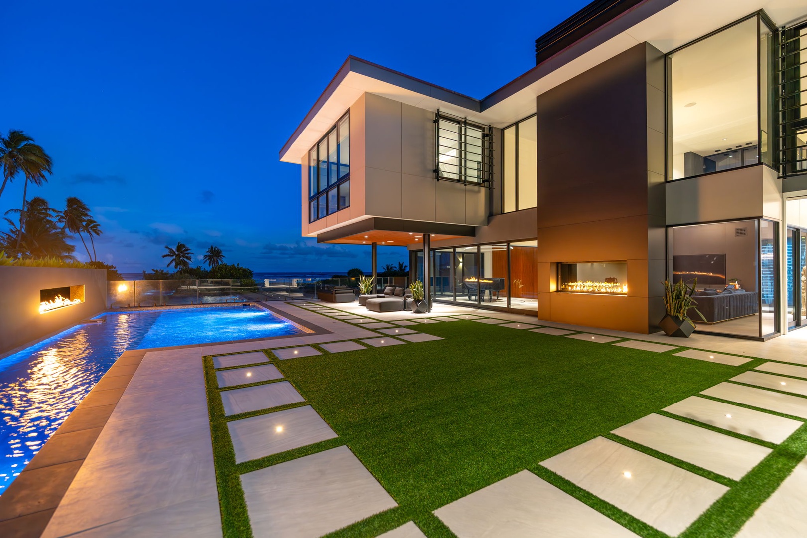Honolulu Vacation Rentals, Ocean Villa Emilie - Evenings shimmer across the manicured lawn and pool deck—perfect for entertaining or a romantic sunset swim.
