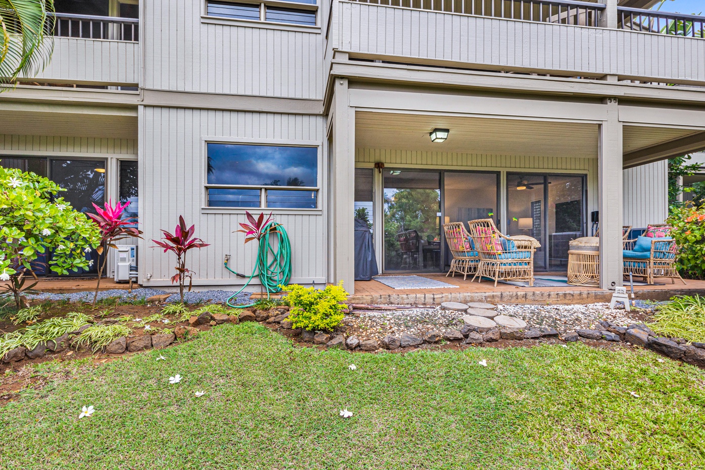 Kihei Vacation Rentals, Wailea Ekolu 1605 - A cozy lanai with seating, providing a comfortable space to relax and enjoy the surrounding greenery.