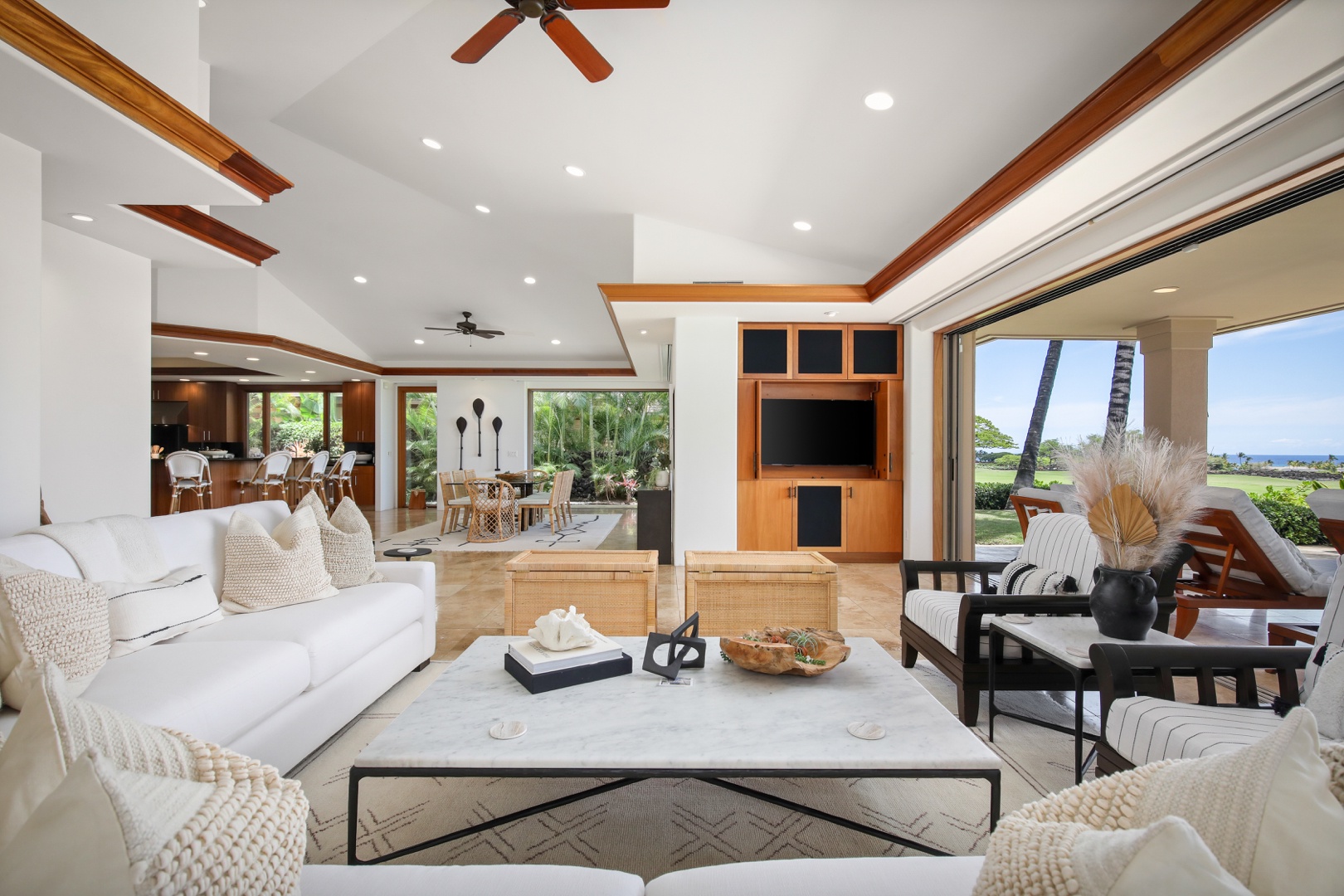 Kailua Kona Vacation Rentals, 4BD Pakui Street (147) Estate Home at Four Seasons Resort at Hualalai - Living room with elegant seating, built in entertainment system, view of the pool deck & ocean beyond.