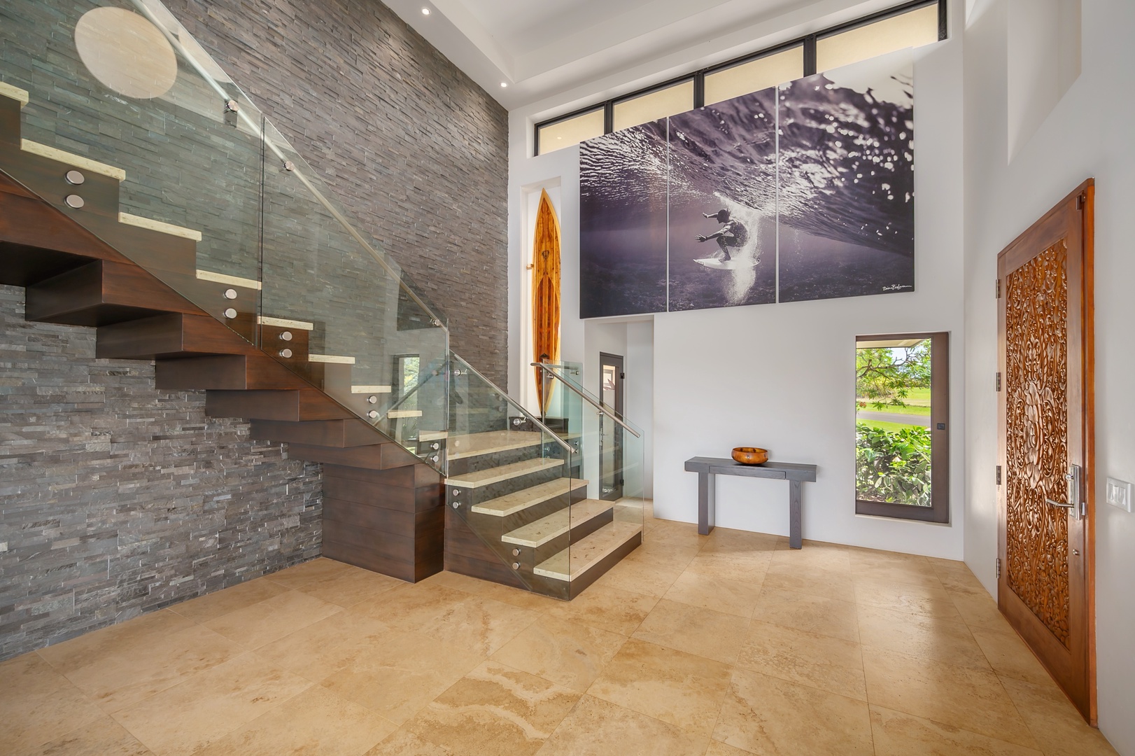 Princeville Vacation Rentals, Hanalei Plantation Villa - Elegant staircase with a modern glass railing, adding a sleek touch to the villa’s interior design.