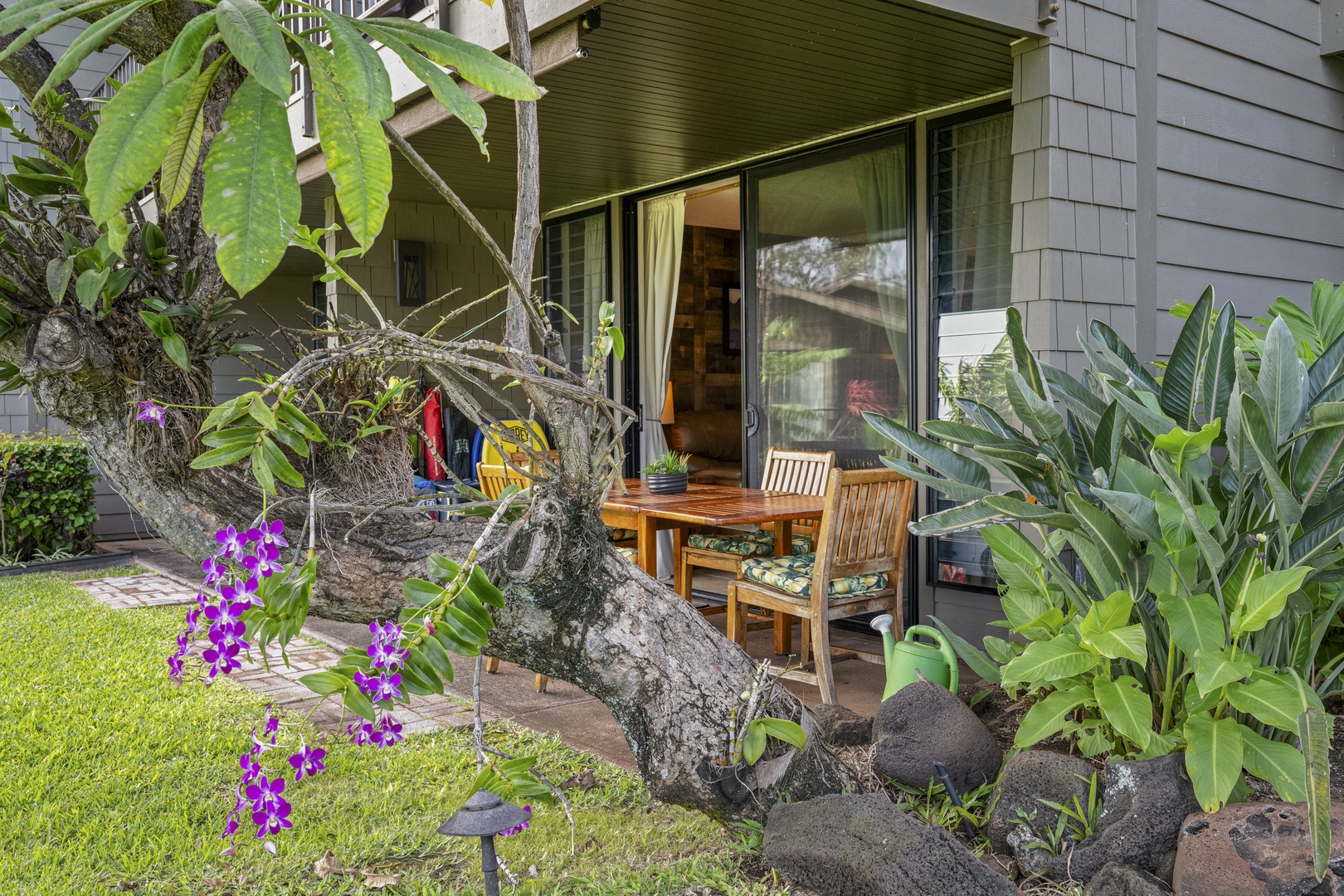 Lahaina Vacation Rentals, Polynesian Shores 114 - Step out to the shaded lanai, an outdoor table set and ready among the tropical greenery.