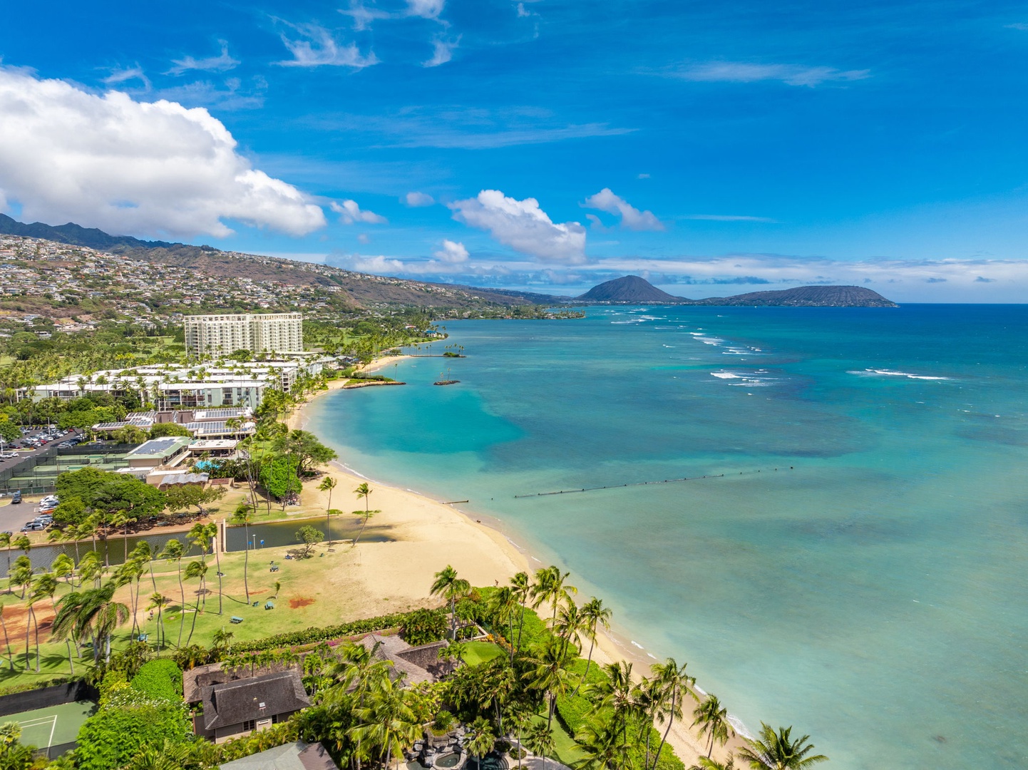 Honolulu Vacation Rentals, Kahala Oasis - Gorgeous aerial view of the coastline with sandy beaches and clear blue water, ideal for enjoying tropical paradise.