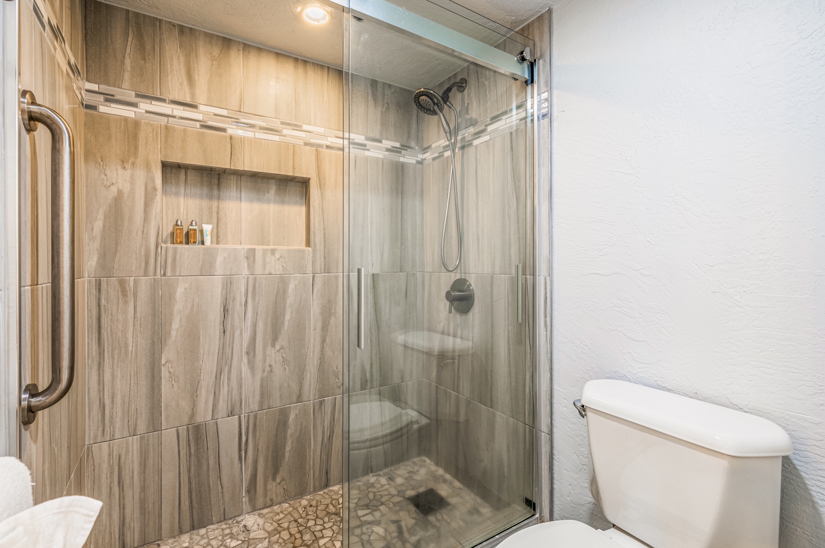 Lahaina Vacation Rentals, Papakea K-105 - The bathroom features a modern glass-enclosed walk-in shower with elegant tile work, providing a luxurious and refreshing experience