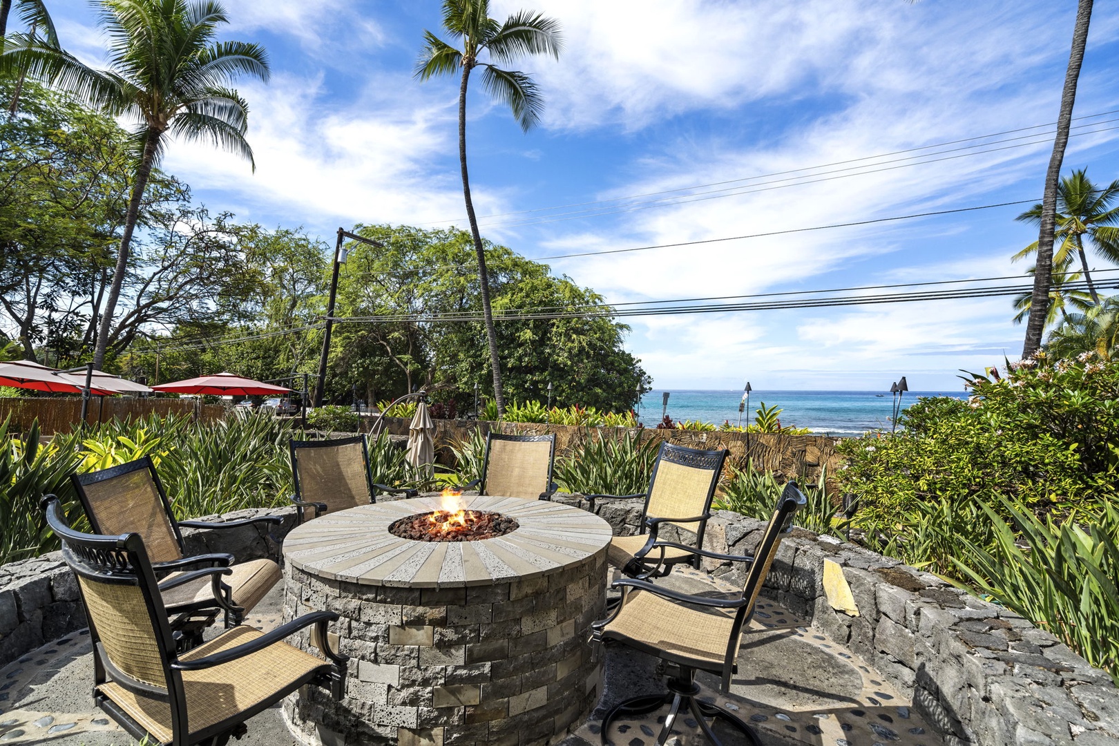 Kailua Kona Vacation Rentals, Royal Kahili 401A - Firepit lounge with seating for six, perfect for evening gatherings by the ocean.