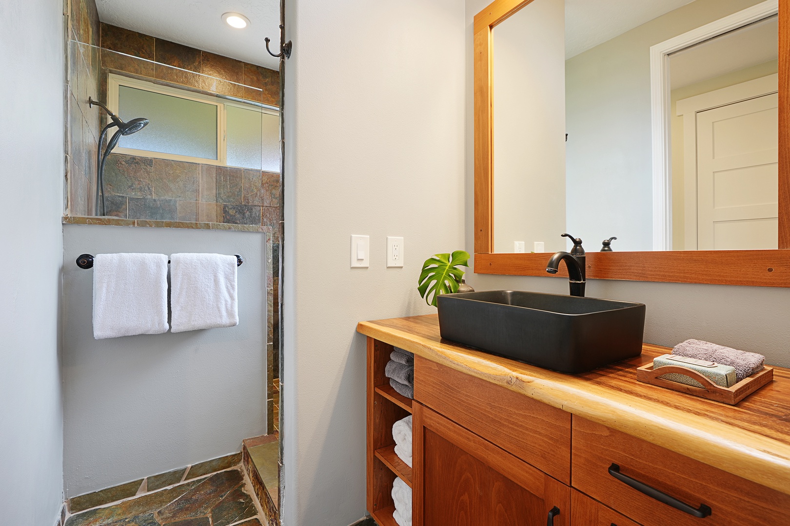 Princeville Vacation Rentals, Pohaku Villa - Your private bathroom features modern touches with a sleek black vessel sink, warm wood vanity, and rejuvenating walk-in shower.