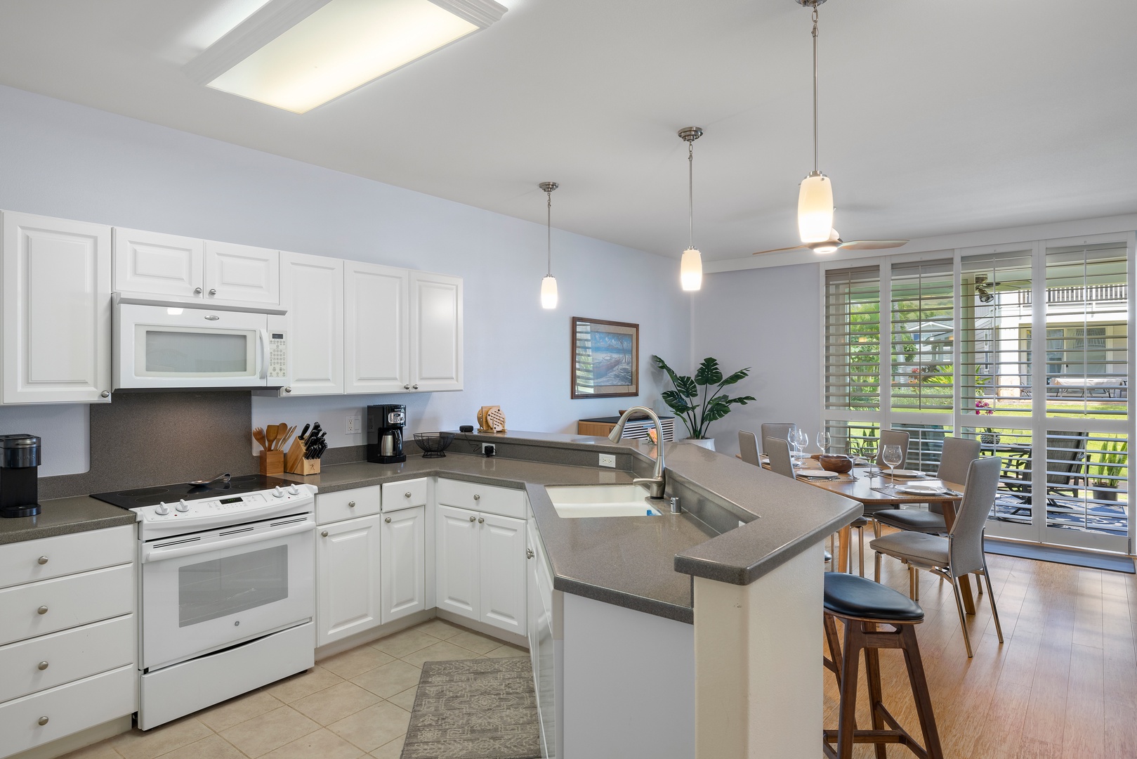 Your bright, open kitchen awaits with modern appliances and a breakfast bar perfect for morning coffee or casual meals together.