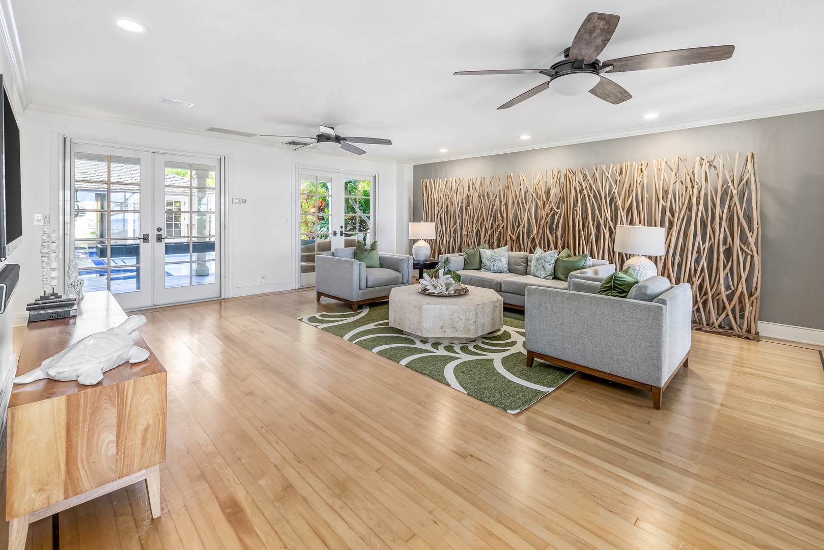 Honolulu Vacation Rentals, Moana Lani - Spacious living room with contemporary décor, ceiling fans, and open flow to the lanai.