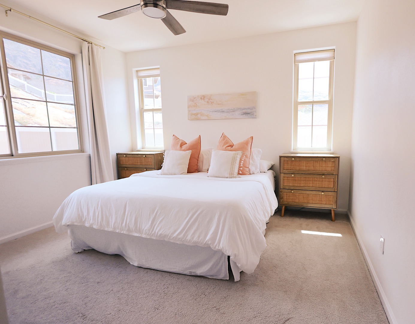 Makaha Valley Vacation Rentals, Makaha Vista Retreat** - Rest easy in the tranquil primary suite with king bed, natural light, and ceiling fan.