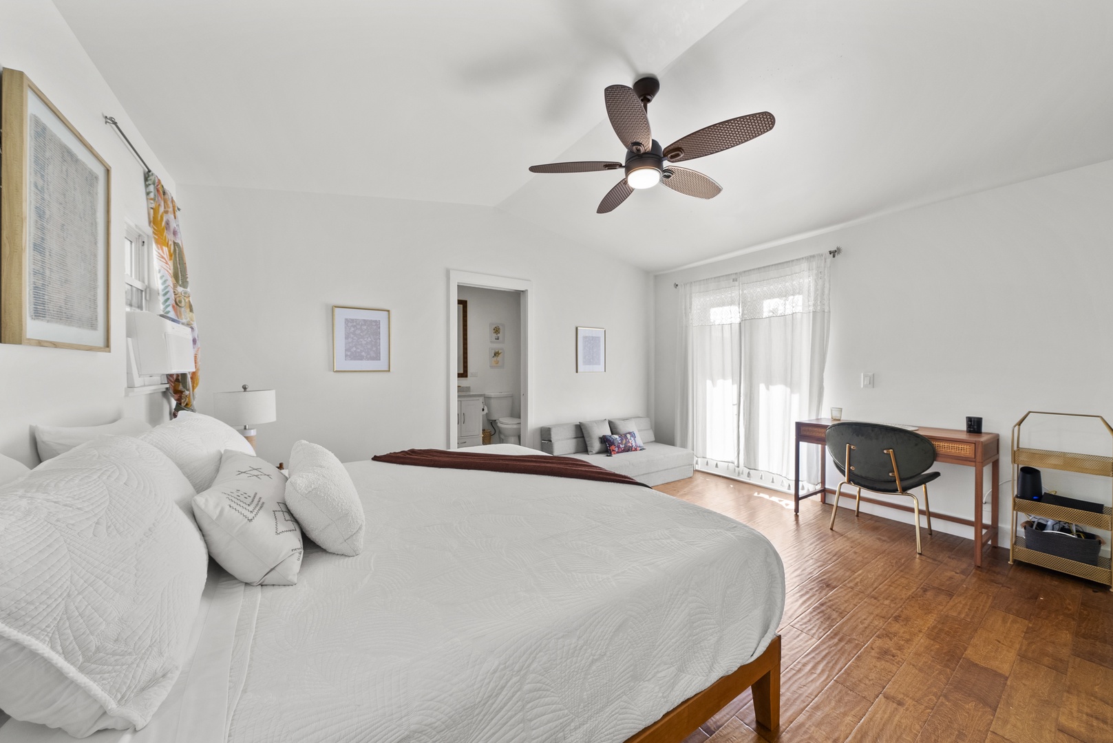 Kaaawa Vacation Rentals, Ka'a'awa Hale - Spacious bedroom with cozy seating, ample natural light, and direct patio access.