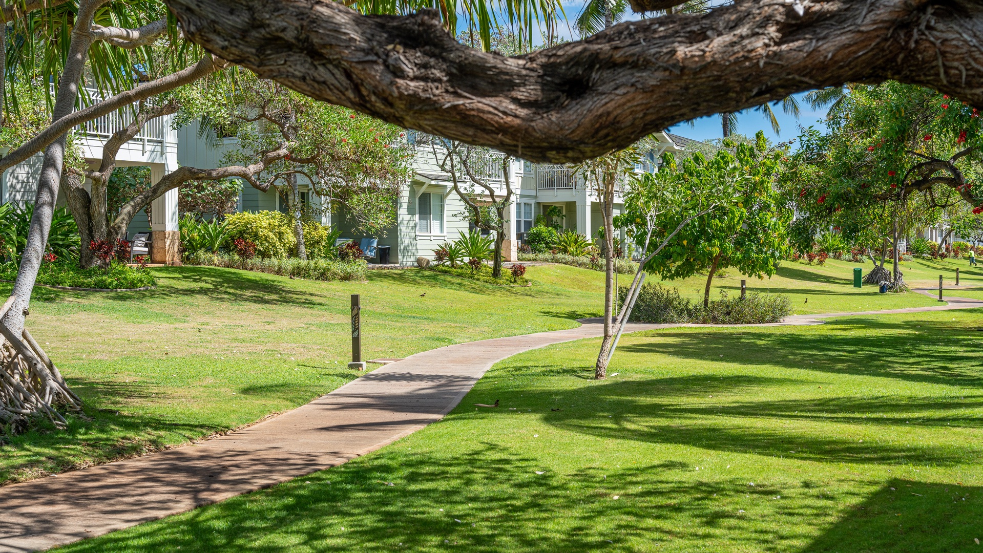 Kapolei Vacation Rentals, Ko Olina Kai 1027A - A paved walkway through manicured lawns outside the home.