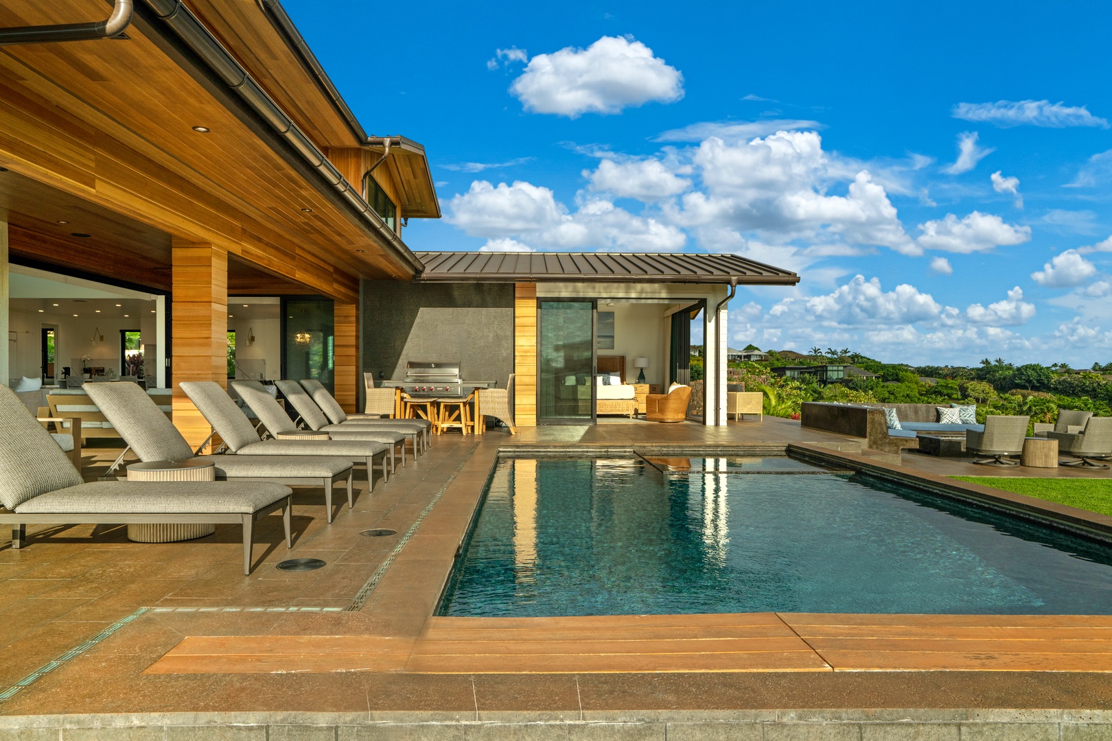 Koloa Vacation Rentals, Hale Laule'a at Kukui'ula - Stunning modern property featuring a private pool and hot tub, outdoor dining area, and expansive terrace with panoramic views of lush tropical landscape.