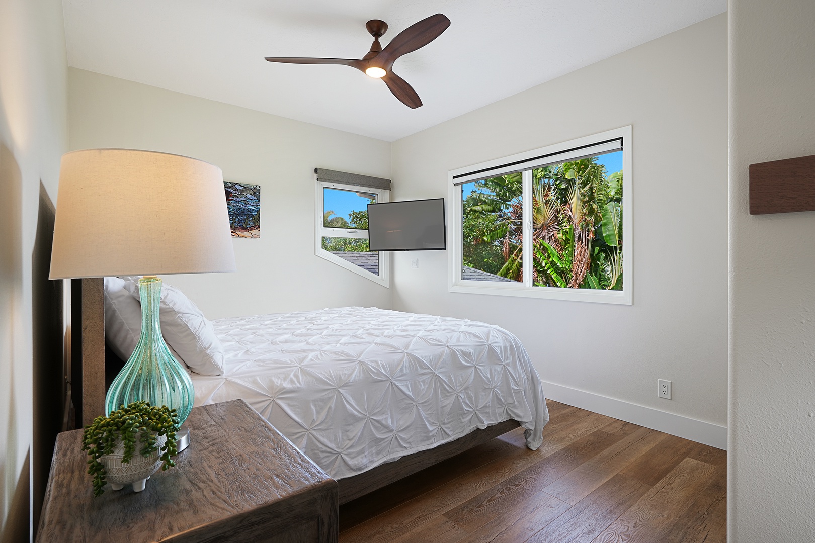 Princeville Vacation Rentals, Pohaku Villa - Drift off in your peaceful bedroom sanctuary with tropical garden views through bright windows and gentle ceiling fan breezes.