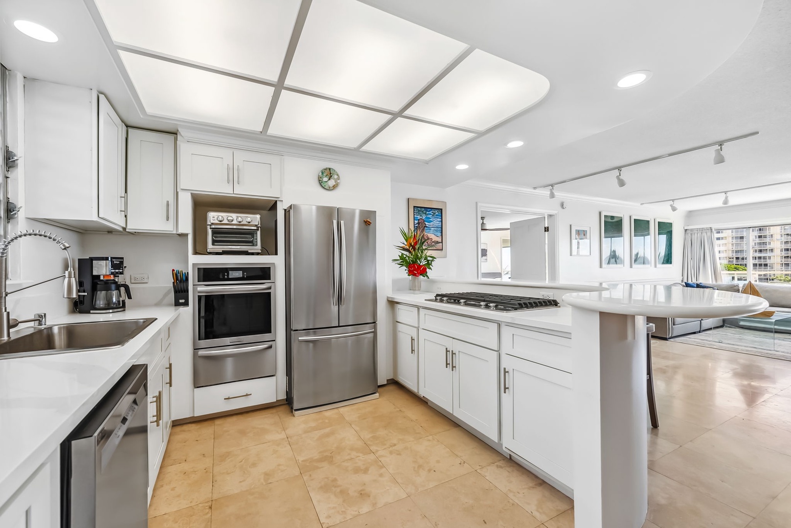 Honolulu Vacation Rentals, Colony Surf Getaway - Sleek, fully-equipped kitchen that opens up to a luxurious living space, perfect for entertaining or leisure.