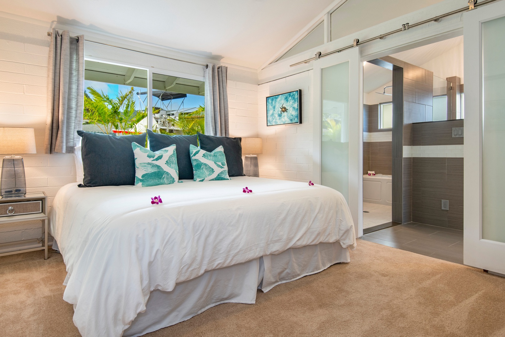 Honolulu Vacation Rentals, Holoholo Hale - Primary bedroom, king bed, split ac, and en-suite bathroom that leads out to the lanai and marina.