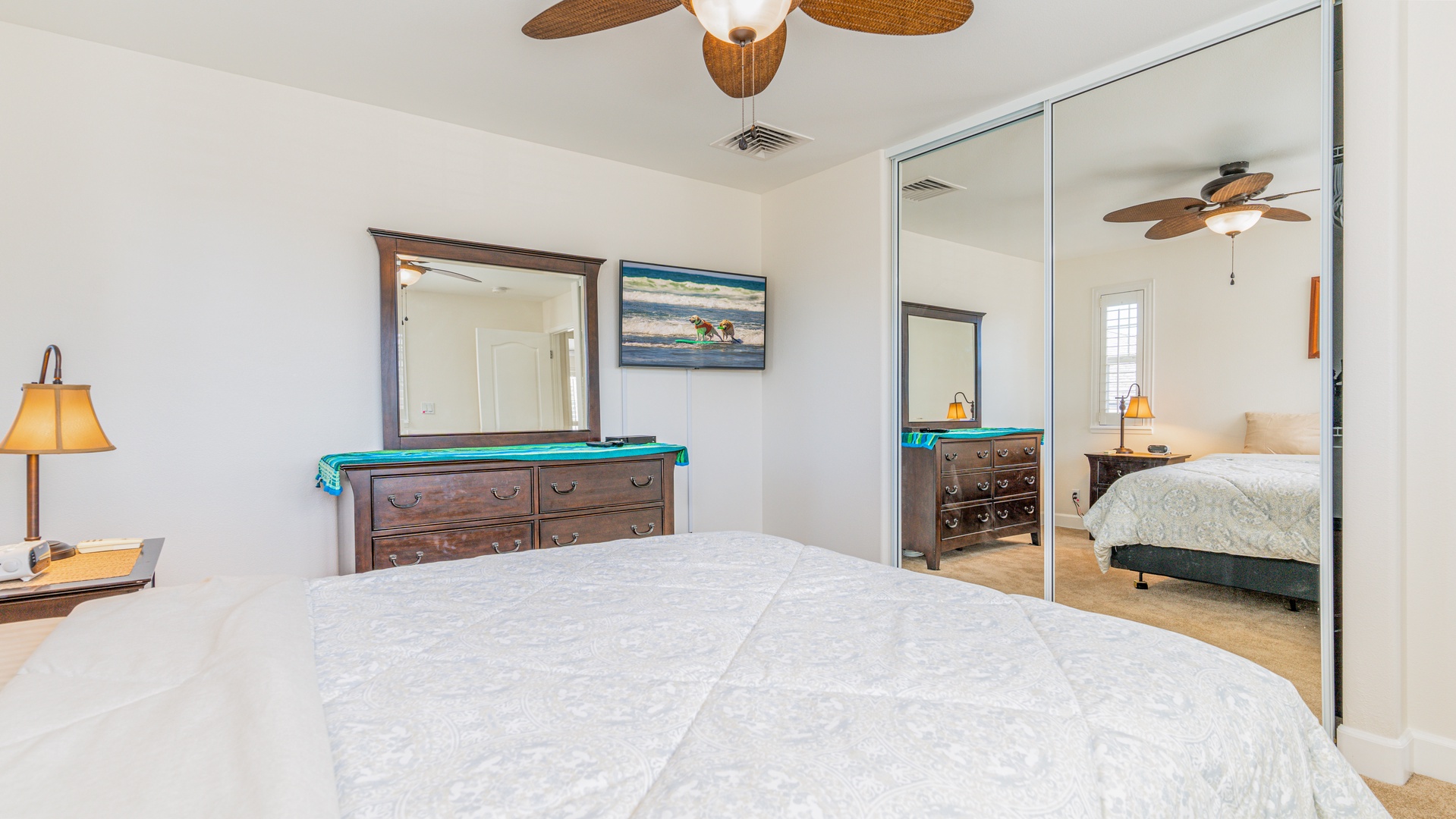 Kapolei Vacation Rentals, Ko Olina Kai 1057B - The second guest bedroom featuring a ceiling fan and large mirror.