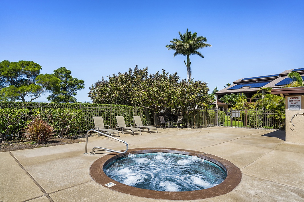 Waikoloa Vacation Rentals, Waikoloa Villas F-100 - Soak under the stars in one of two hot tubs available to guests, surrounded by tropical landscaping and palm trees.