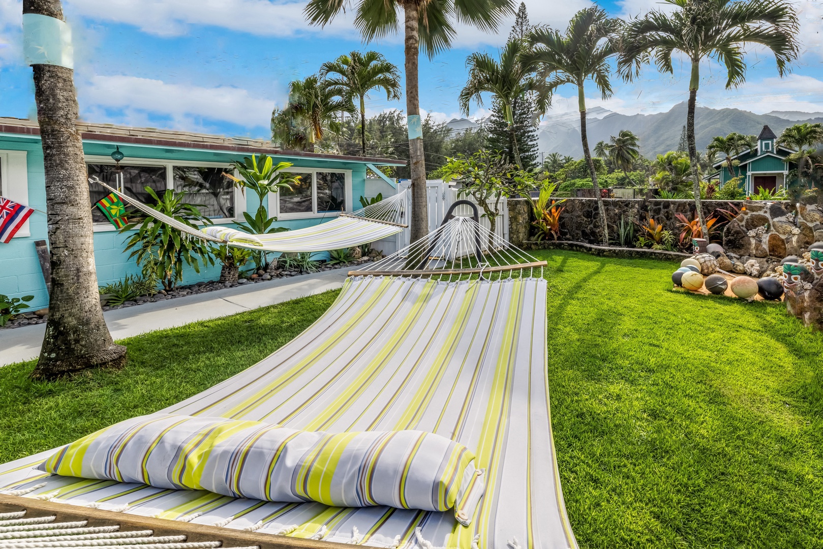 Hauula Vacation Rentals, Private Beach Paradise - Drift into tropical bliss on your private hammock, surrounded by swaying palms and mountain vistas in this lush garden paradise.