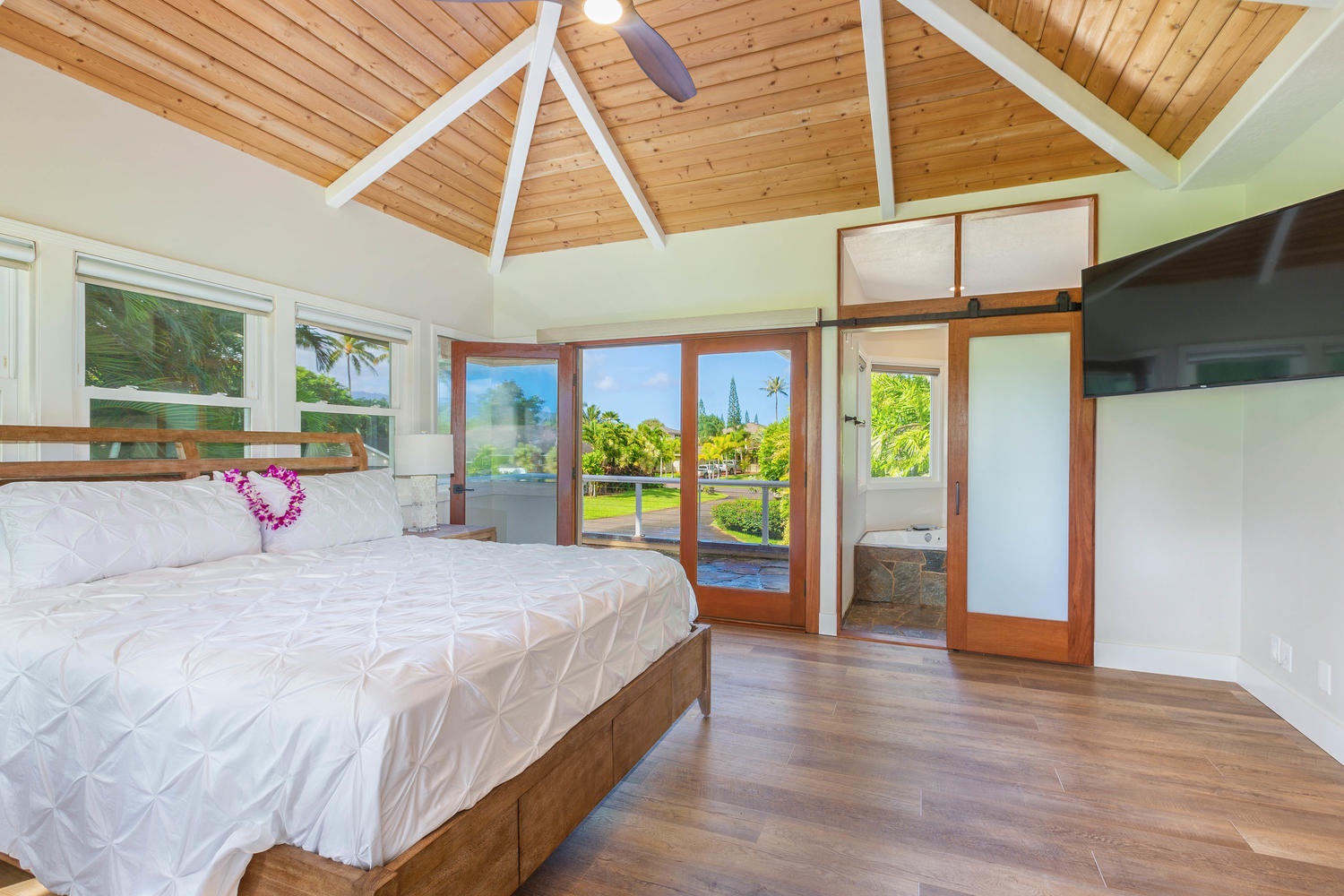 Princeville Vacation Rentals, Pohaku Villa - The primary suite upstairs has a king-sized bed, TV, split AC and private lanai access.