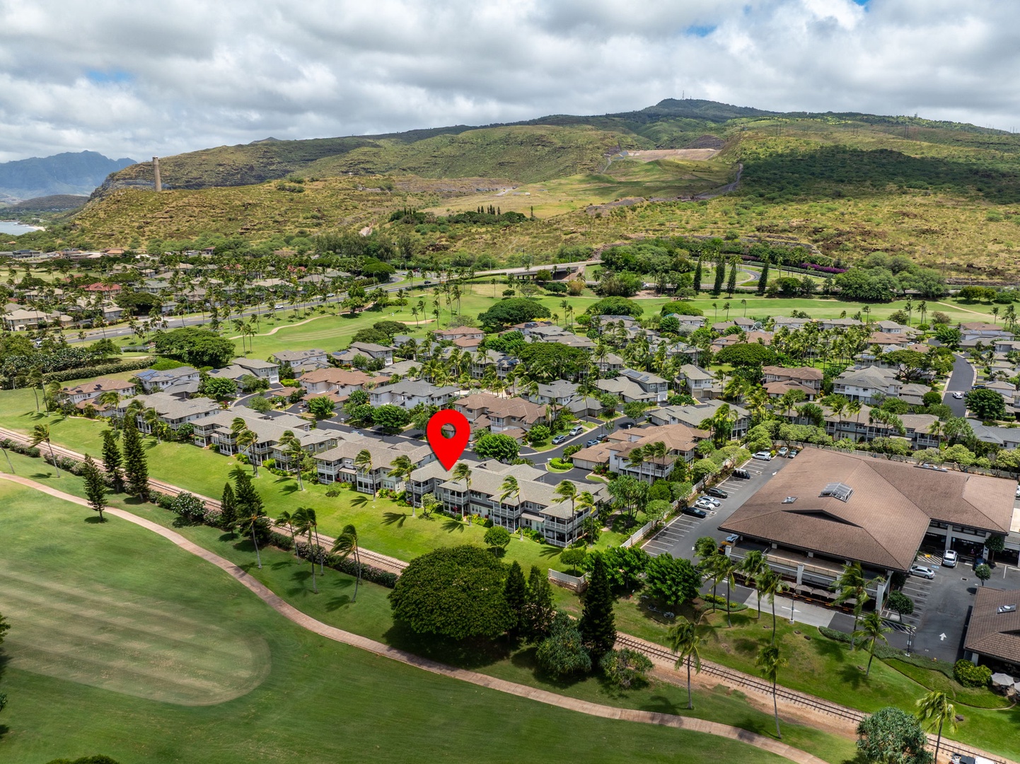 Kapolei Vacation Rentals, Coconut Plantation 1080-4 - The drone view frames the home against green hills and the wider resort.
