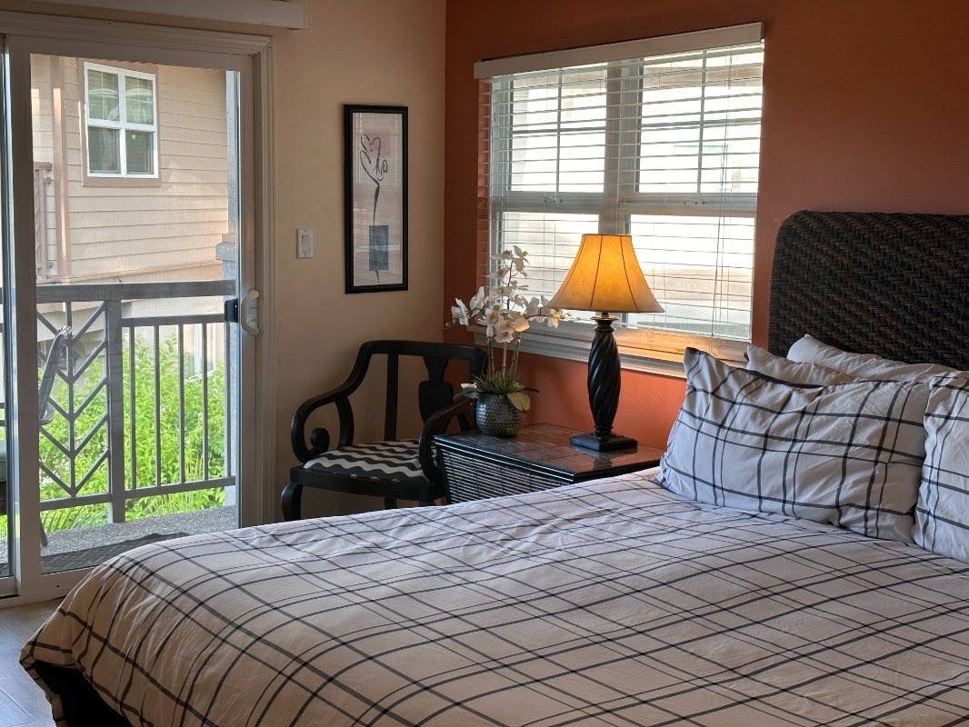 Waikoloa Vacation Rentals, Waikoloa Colony Villas 2101 - Primary suite with a plush king bed, soft linens and a private balcony for your tranquil sanctuary. Complete with a walk-in closet, ensuite bathroom w/ separate glass shower, soaking tub and dual sink vanity.