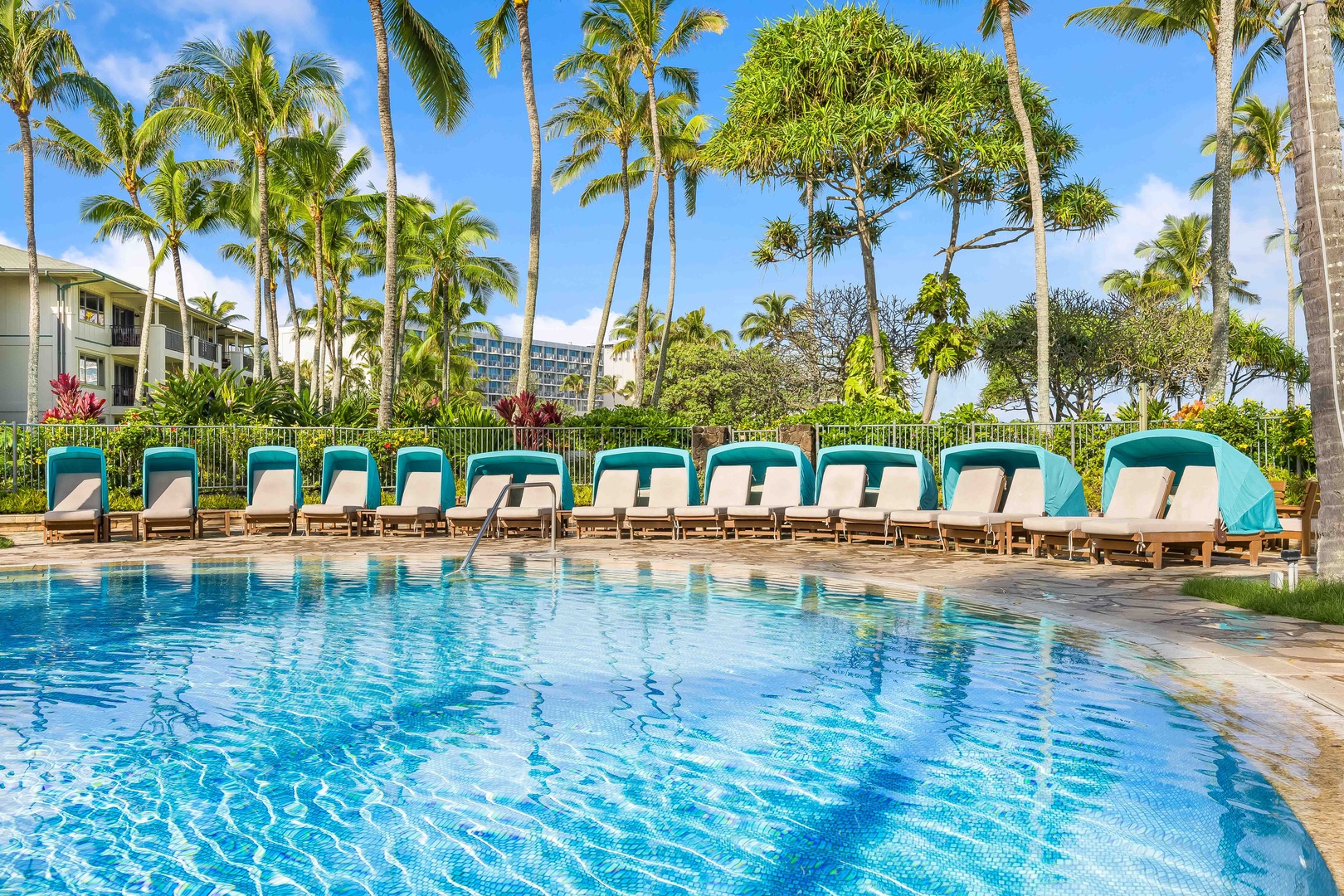 Kahuku Vacation Rentals, Turtle Bay Villas 209 - Tropical paradise awaits with crystal-clear pool waters, comfortable loungers, and swaying palms creating your perfect Hawaiian escape.