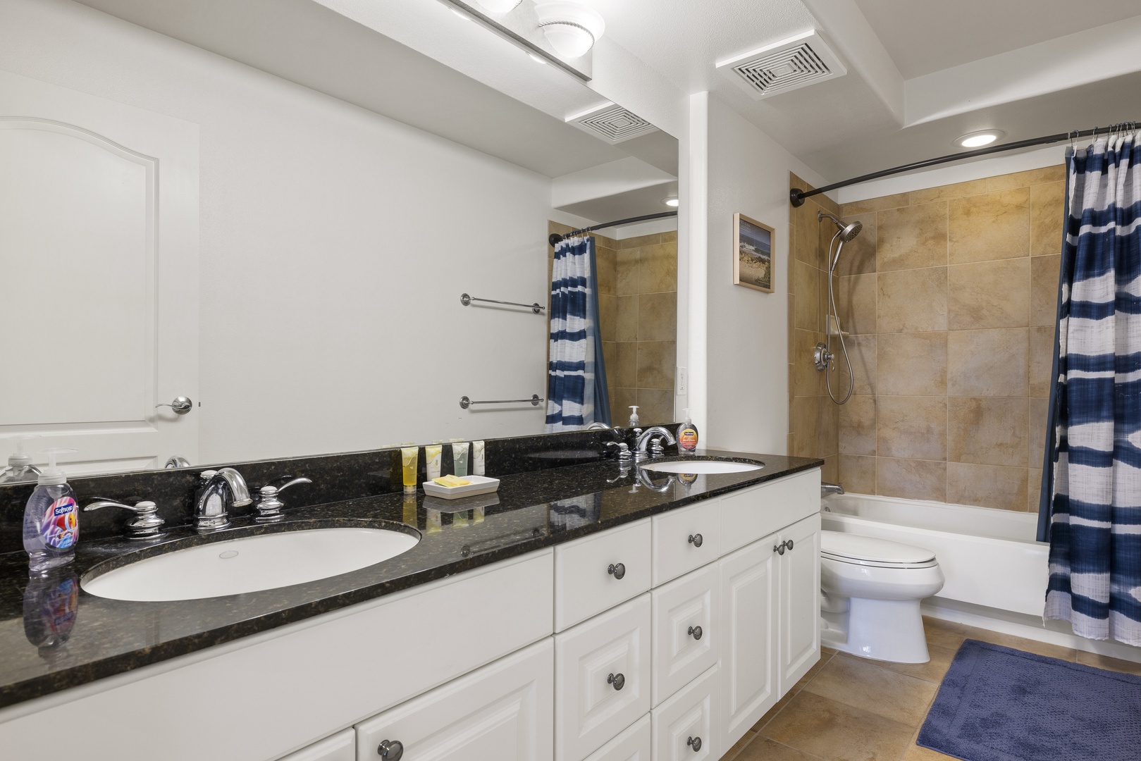 Clean, bright, and thoughtfully designed, the full bathroom includes a tub-shower combination and generous counter space.