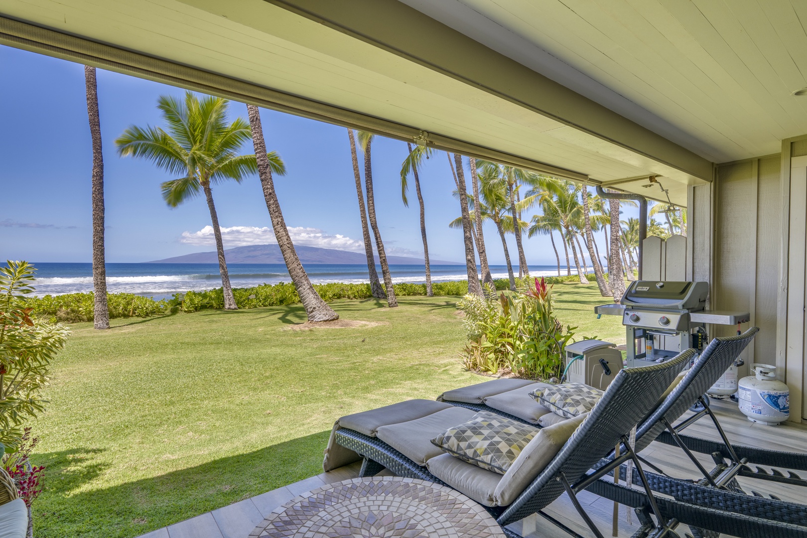 Lahaina Vacation Rentals, Puamana 240-3 - Experience outdoor living at its best with a lanai offering stunning vistas of palm trees and the sea.