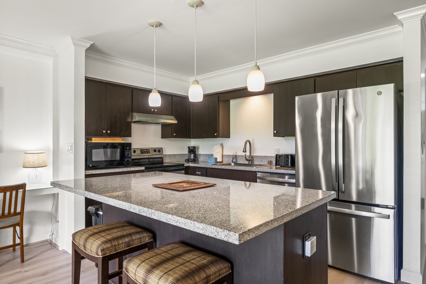 Kihei Vacation Rentals, Koa Resort 1B - A granite island with bar seating, roomy enough for cooking elaborate island dinners or grabbing a quick bite before heading out the door.