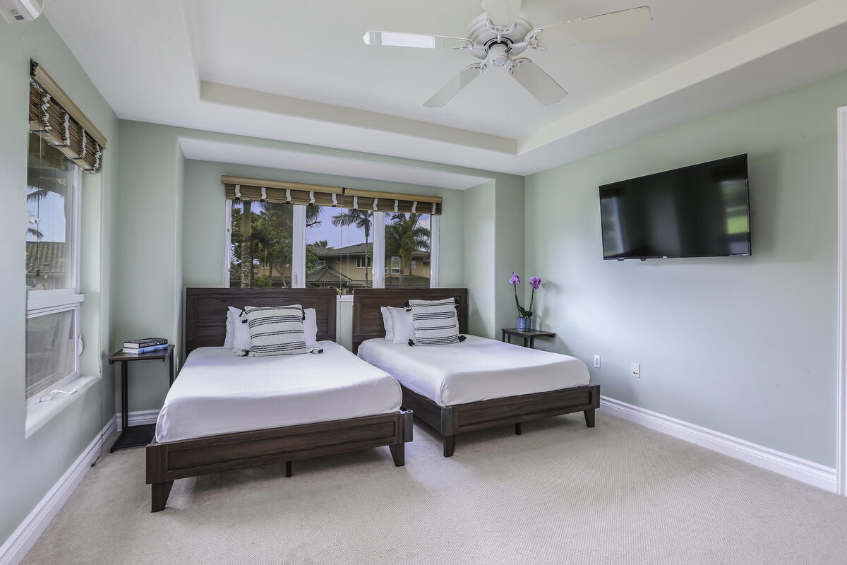 Princeville Vacation Rentals, Ho'onanea - The 2nd bedroom is furnished with two full size beds, flatscreen TV, workspace area and includes its own ensuite with walk-in shower