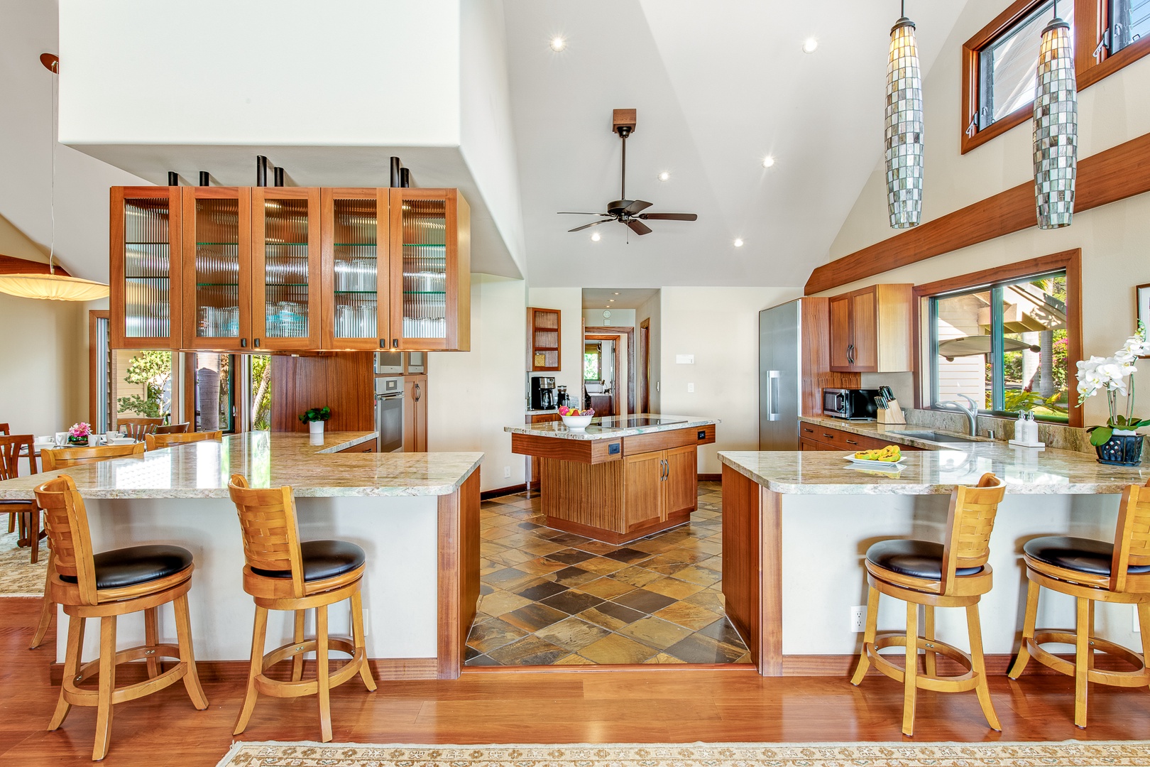 Kamuela Vacation Rentals, Olomana Hale at Kohala Ranch - The kitchen is outfitted with beautiful granite countertops and all stainless steel Miele appliances, a wine fridge, a large central island, and two breakfast bars with six bar stools for entertaining during mealtimes