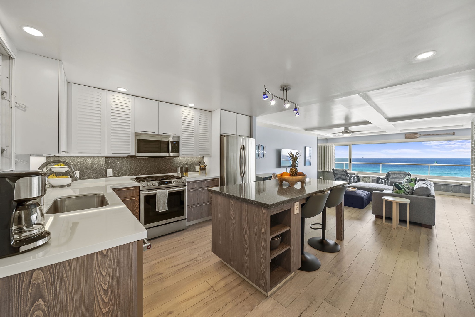 Honolulu Vacation Rentals, Kaimana Tides at Colony Surf - Your open-concept kitchen flows seamlessly into the living space, where ocean views greet you through expansive windows.