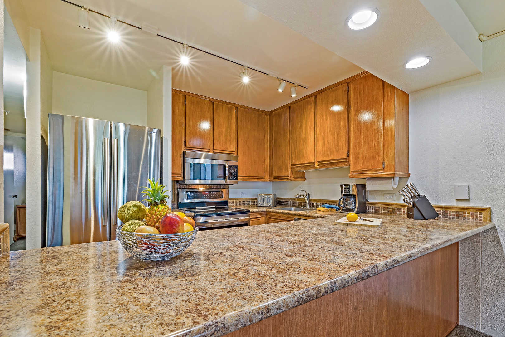 Lahaina Vacation Rentals, Kaanapali Shores 544 - The kitchen features modern stainless steel appliances and a spacious countertop, providing plenty of room for meal prep and casual dining